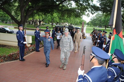 Maj. Gen. Mohammad Dawran, Afghan National Army Air Corps commander, salutes as he and Gen. Stephen Lorenz (right), Air Education and Training Command commander, walk through the Randolph Honor Guard during Honors Ceremony at AETC Headquarters. (U.S. Air Force photo by Rich McFadden)