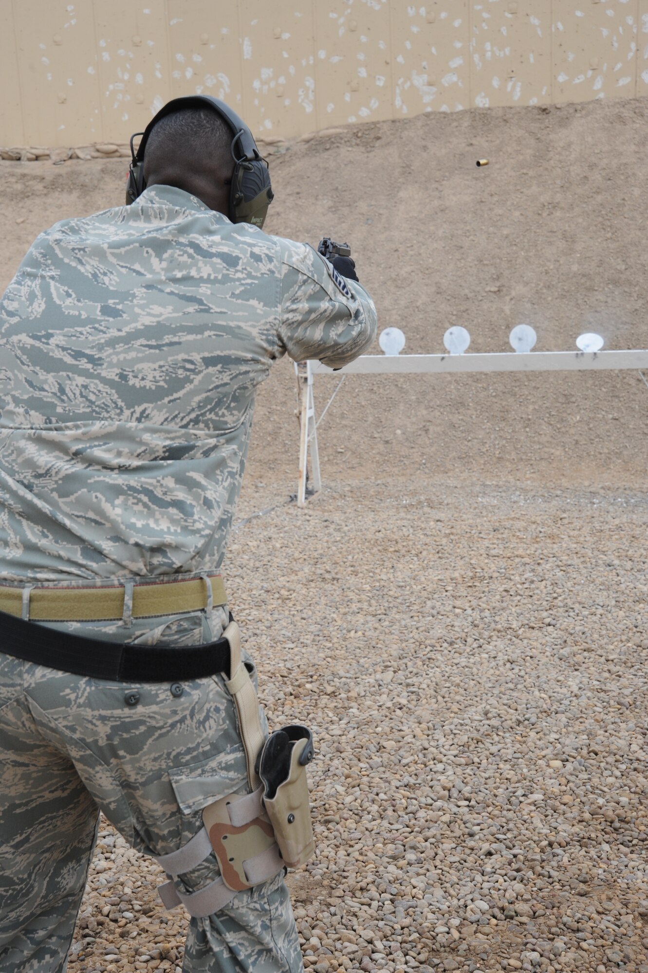 Air Force Master Sgt. Robert Zackery, Det 2, 82nd Expeditionary Air Support Operations Squadron Tactical Air Control Party NCOIC practices on targets during a tactical shoot with his 9 mm pistol March 26, to hone his skills while in the area of operation. Sergeant Zackery is deployed from U.S. Army Garrison Heidelberg, Germany. (U.S. Air Force photo/Senior Airman Jarrod R. Chavana)