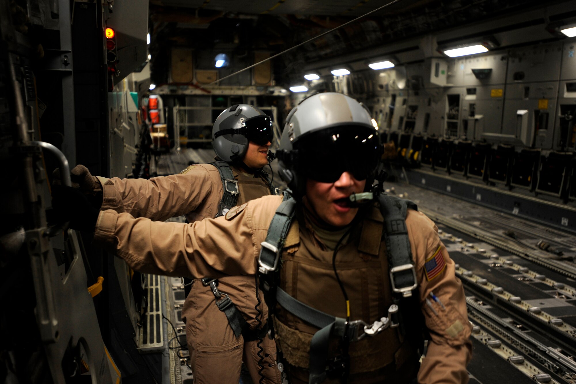 Staff Sgt. Gabriel Reams, foreground, and Senior Airman Brandon Ybarra, both C-17A Globemaster III loadmasters assigned to the 816th Expeditionary Airlift Squadron, celebrate after successfully air-dropping 40 container delivery systems, or bundles, from a C-17A May 9, 2010, over Afghanistan. (U.S. Air Force photo/Staff Sgt. Manuel J. Martinez,released)
