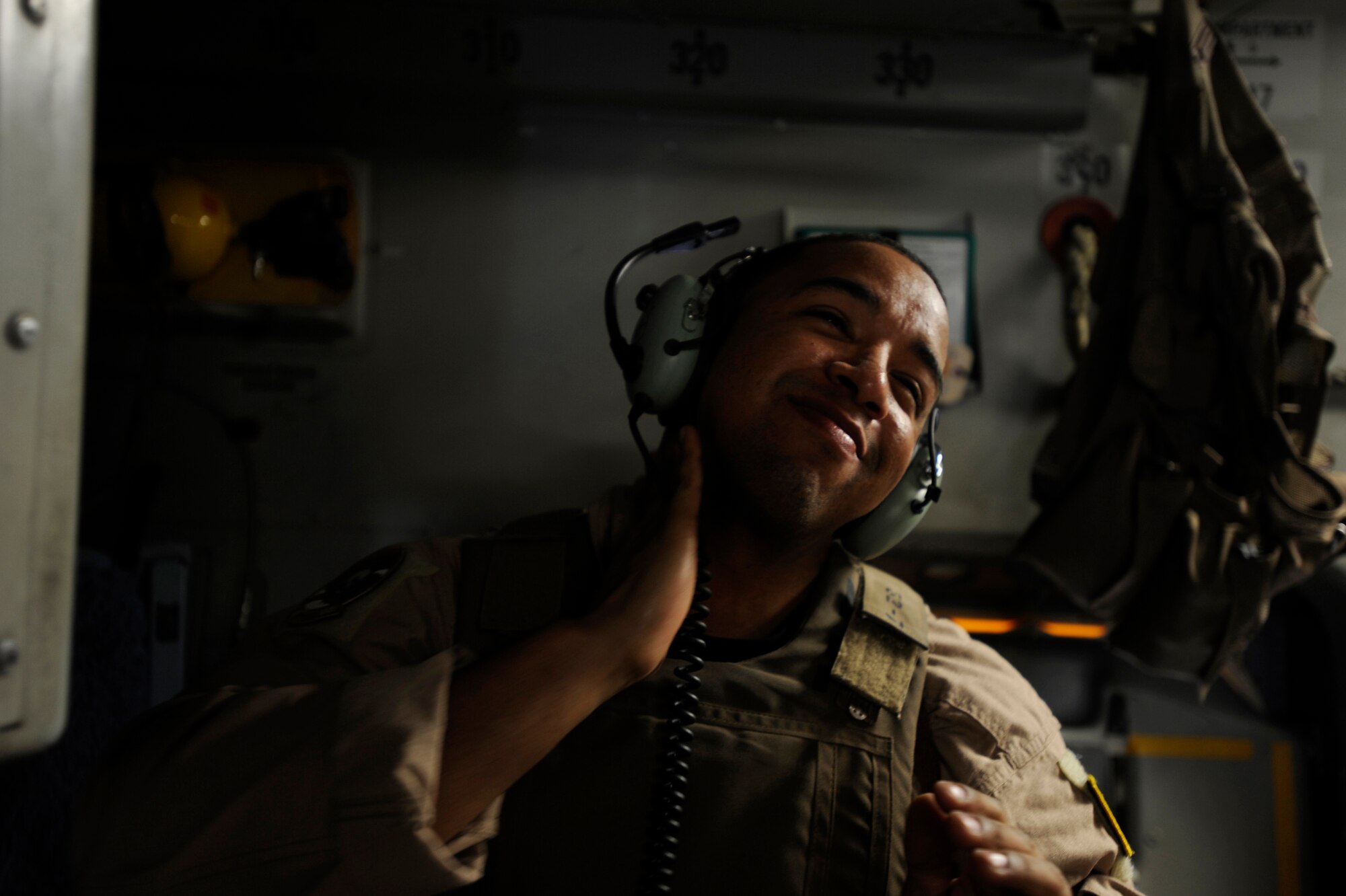 Senior Airman Kevin Johnson, a C-17 Globemaster III loadmaster assigned to the 816th Expeditionary Airlift Squadron, puts on aftershave, affectionatley known as ''combat musk,'' May 9, 2010, over Afghanistan. Before every combat airdrop the crew puts on their ?combat musk? scent for good luck. (U.S. Air Force photo/Staff Sgt. Manuel J. Martinez, released)