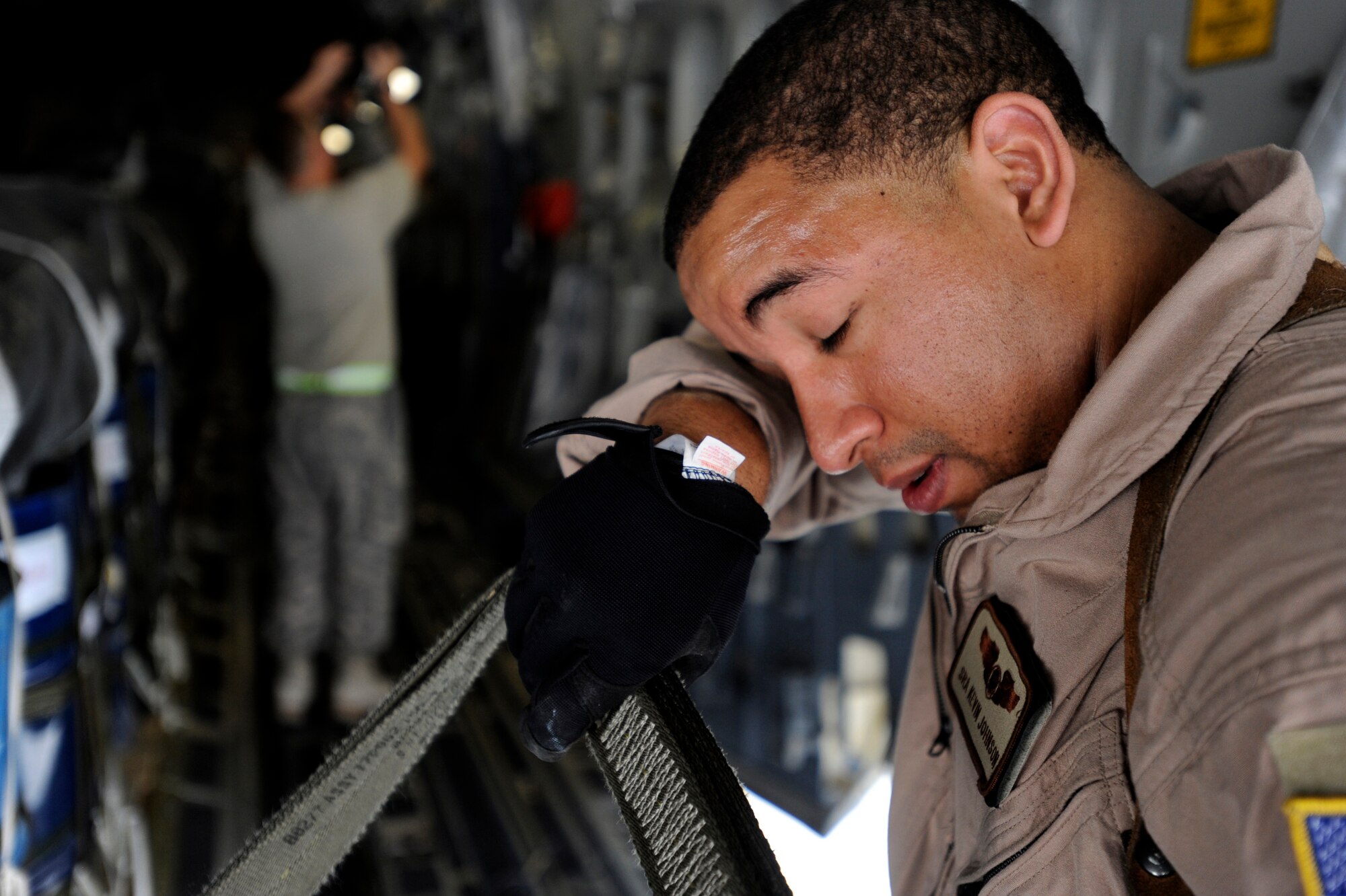 Senior Airman Kevin Johnson, a C-17 Globemaster III loadmaster assigned to the 816th Expeditionary Airlift Squadron, secures container delivery system bundles on a C-17 prior to an airdrop mission, May 9, 2010, at a base in Southwest Asia. (U.S. Air Force photo/Staff Sgt. Manuel J. Martinez, released)
