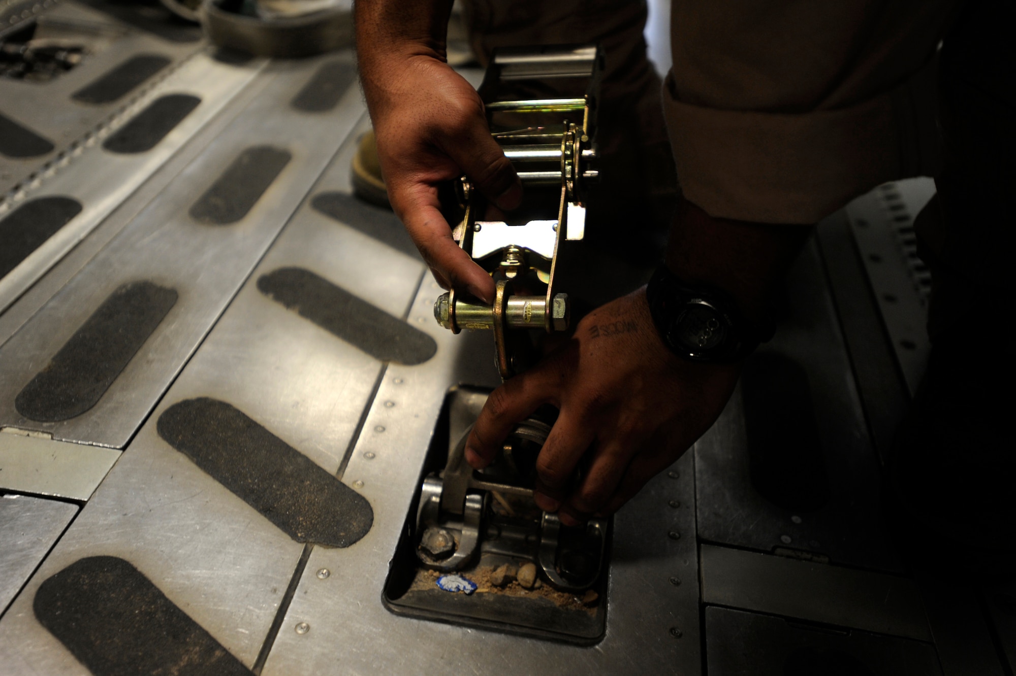 Senior Airman Kevin Johnson, a C-17 Globemaster III loadmaster assigned to the 816th Expeditionary Airlift Squadron, secures container delivery system bundles on a C-17 prior to an airdrop mission, May 9, 2010, at a base in Southwest Asia. (U.S. Air Force photo/Staff Sgt. Manuel J. Martinez, released)
