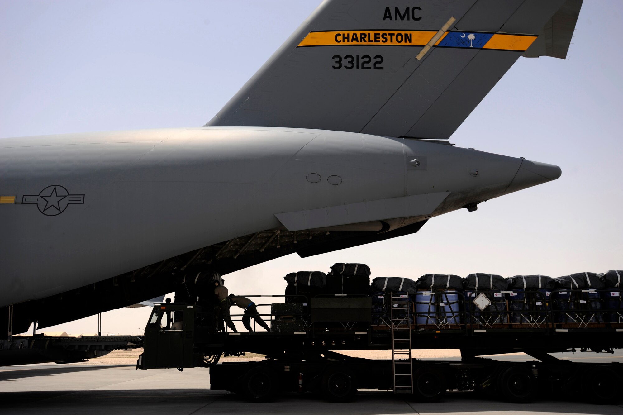 Aerial porters assigned to the 8th Expeditionary Aircraft Maintenance Squadron, load container delivery system bundles onto a C-17 Globemaster III for an airdrop mission, May 9, 2010, at a base in Southwest Asia. Airmen deployed from the 8th Airlift Squadron at Joint Base Lewis-McChord took over airdrop operations from the 14th Airlift Squadron deployed from Joint Base Charleston, S.C. The 14th AS Airmen set a new record for the number of bundles and amount of weight airdropped during an Expeditionary Airlift Squadron deployment. They completed missions over 160 drop zones, delivering more than 5,000 bundles, which in turn resulted in more than 8.1 million pounds of supplies distributed to warfighters throughout the theater. (U.S. Air Force photo/Staff Sgt. Manuel J. Martinez, released)