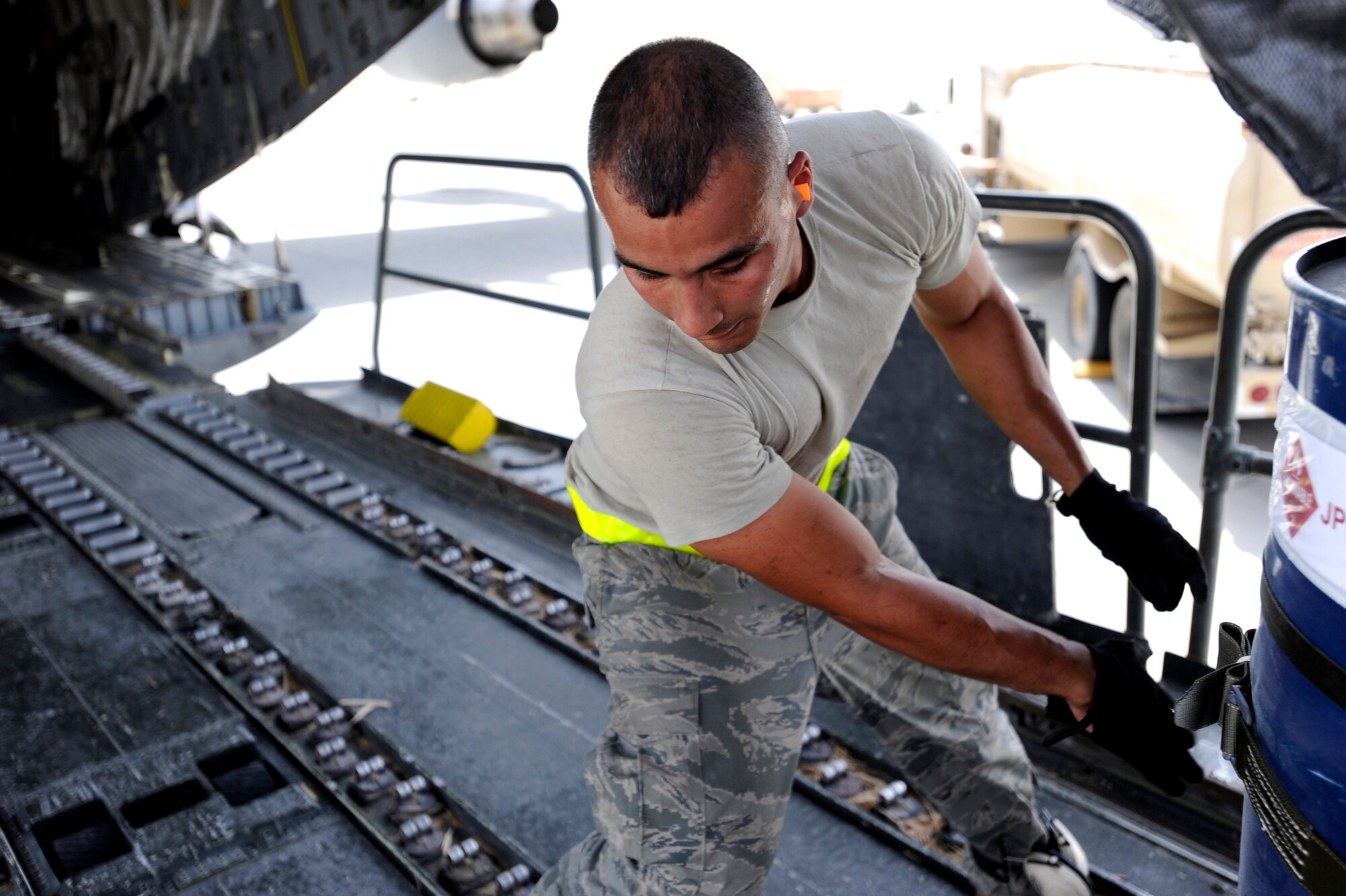 Senior Airman Jason Caro, an aerial porter assigned to the 8th Expeditionary Aircraft Maintenance Squadron, loads container delivery system bundles aboard a C-17 Globemaster III for an airdrop mission, May 9, 2010, at a base in Southwest Asia. (U.S. Air Force photo/Staff Sgt. Manuel J. Martinez, released)