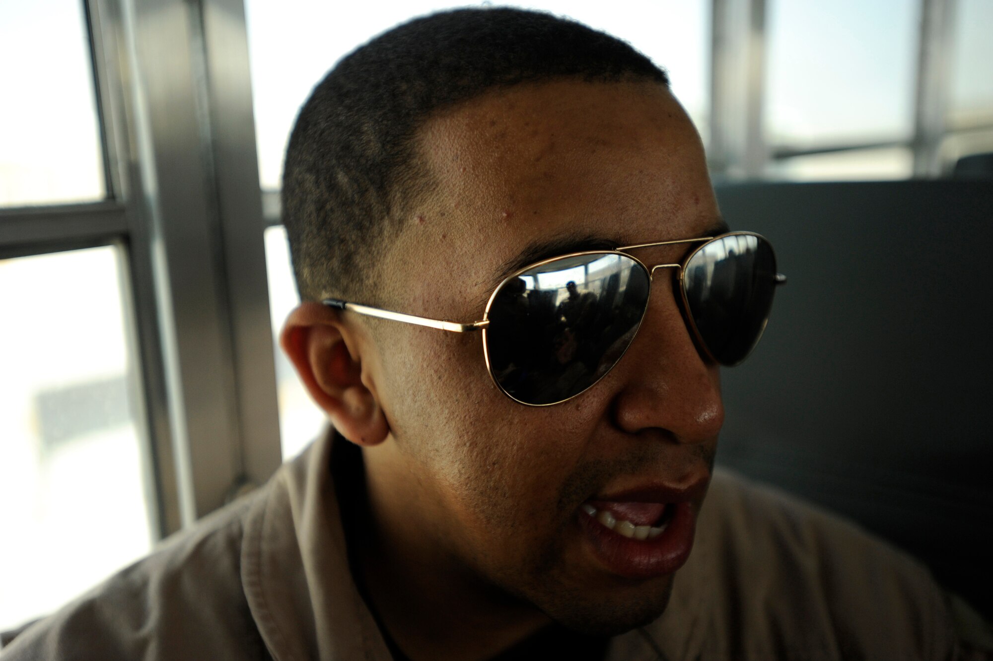 Senior Airman Kevin Johnson, a C-17A Globemaster III loadmaster assigned to the 816th Expeditionary Airlift Squadron, speaks with fellow aircrew members while being transported to a C-17A aircraft for an airdrop mission, May 9, 2010, at a base in Southwest Asia. The McChord Airmen are replacing Airmen from 14th Airlift Squadron who are returning to Joint Base Charleston, S.C., after a four-month deployment. (U.S. Air Force photo/Staff Sgt. Manuel J. Martinez, released)