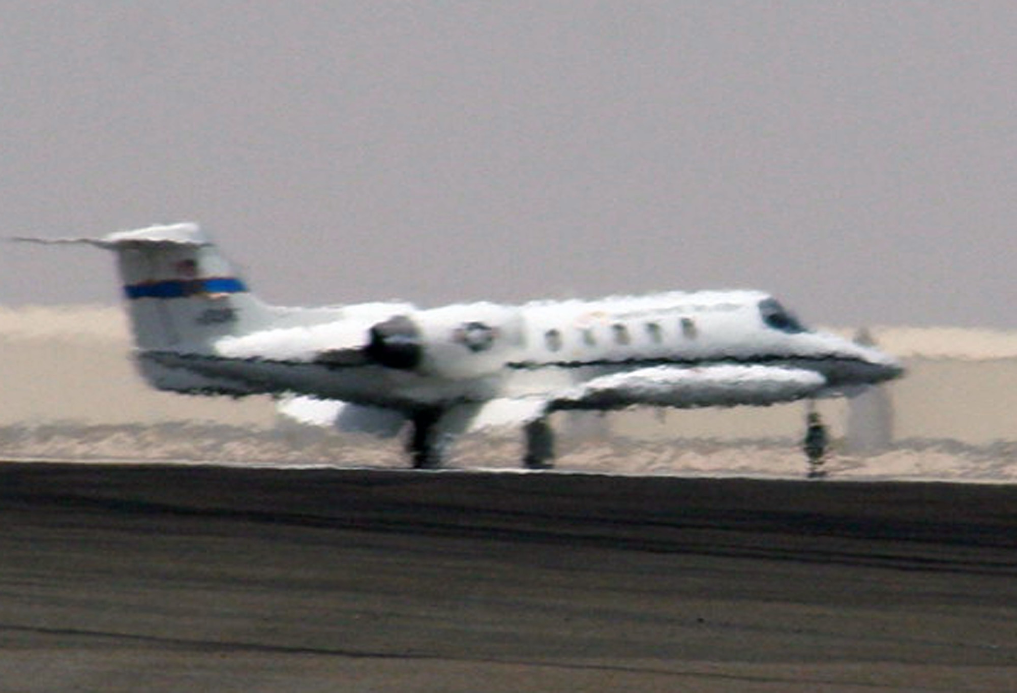A C-21 passenger jet comes in for a landing to the 380th Air Expeditionary Wing area of operations at a non-disclosed location in Southwest Asia on May 19, 2010.  The C-21, according to its Air Force fact sheet, is a twin turbofan engine aircraft used for cargo and passenger airlift. The aircraft is the military version of the Lear Jet 35A business jet. In addition to providing cargo and passenger airlift, the aircraft is capable of transporting one litter or five ambulatory patients during aeromedical evacuations. The C-21 can carry eight passengers and 42 cubic feet (1.26 cubic meters) of cargo. (U.S. Air Force Photo/Master Sgt. Scott T. Sturkol/Released)