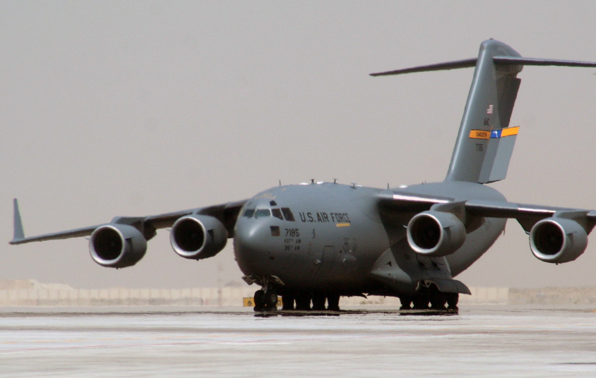 A C-17 Globemaster III deployed from Joint Base Charleston, S.C., taxis down the runway at a non-disclosed base in Southwest Asia after landing May 19, 2010. The C-17 stopped at the base to deliver cargo and passengers for the 380th Air Expeditionary Wing. According to its Air Force fact sheet, the C-17 Globemaster III is the newest, most flexible cargo aircraft to enter the airlift force. The C-17 is capable of rapid strategic delivery of troops and all types of cargo to main operating bases or directly to forward bases in the deployment area. (U.S. Air Force Photo/Master Sgt. Scott T. Sturkol/Released)
