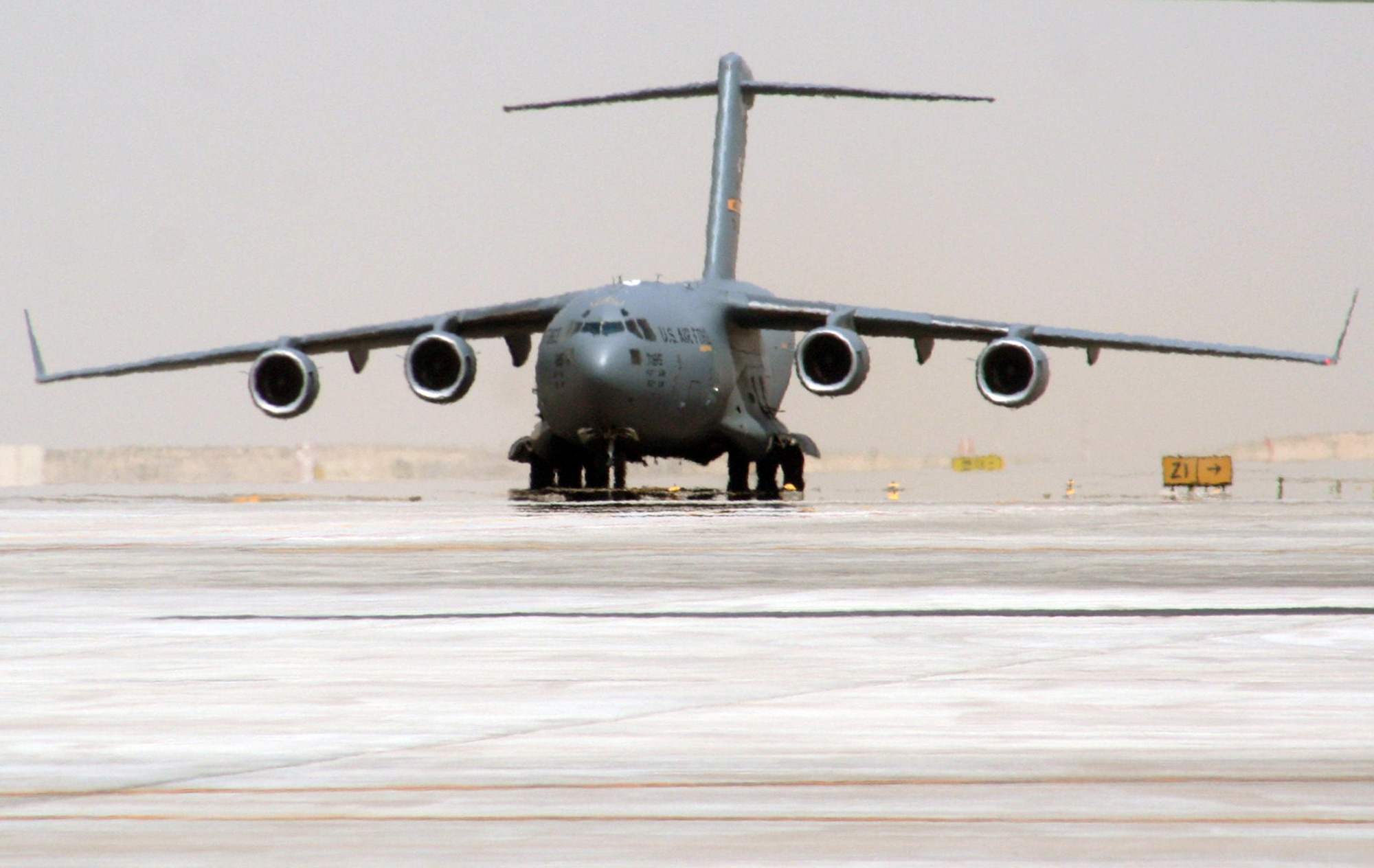 A C-17 Globemaster III deployed from Joint Base Charleston, S.C., taxis down the runway at a non-disclosed base in Southwest Asia after landing May 19, 2010. The C-17 stopped at the base to deliver cargo and passengers for the 380th Air Expeditionary Wing. According to its Air Force fact sheet, the C-17 Globemaster III is the newest, most flexible cargo aircraft to enter the airlift force. The C-17 is capable of rapid strategic delivery of troops and all types of cargo to main operating bases or directly to forward bases in the deployment area. (U.S. Air Force Photo/Master Sgt. Scott T. Sturkol/Released)