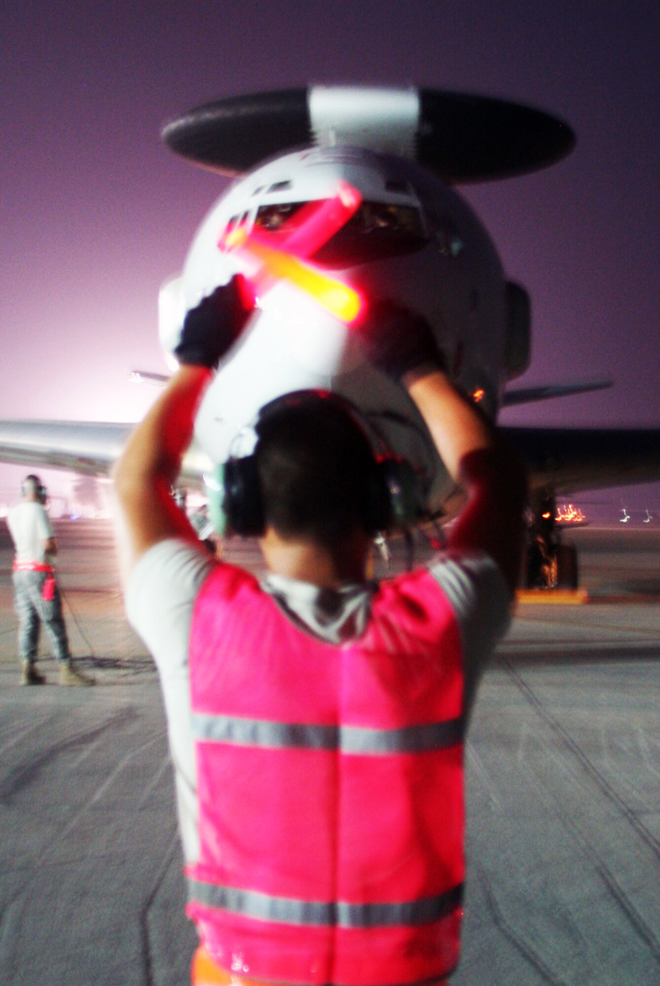 A maintenance Airman from the 380th Expeditionary Aircraft Maintenance Squadron Sentry aircraft maintenance unit uses light sticks to guide an E-3 Sentry Airborne Warning and Control System aircraft to a parking spot on the flightline during operations for the 380th Air Expeditionary Wing at a non-disclosed base in Southwest Asia on May 19, 2010. The E-3 aircraft and the Airmen who support them are deployed from the 552nd Air Control Wing at Tinker Air Force Base, Okla. (U.S. Air Force Photo/Master Sgt. Scott T. Sturkol/Released)