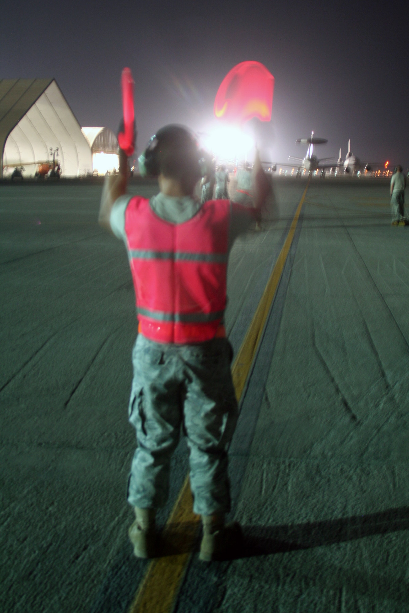 A maintenance Airman from the 380th Expeditionary Aircraft Maintenance Squadron Sentry aircraft maintenance unit uses light sticks to guide an E-3 Sentry Airborne Warning and Control System aircraft to a parking spot on the flightline during operations for the 380th Air Expeditionary Wing at a non-disclosed base in Southwest Asia on May 19, 2010. The E-3 aircraft and the Airmen who support them are deployed from the 552nd Air Control Wing at Tinker Air Force Base, Okla. (U.S. Air Force Photo/Master Sgt. Scott T. Sturkol/Released)