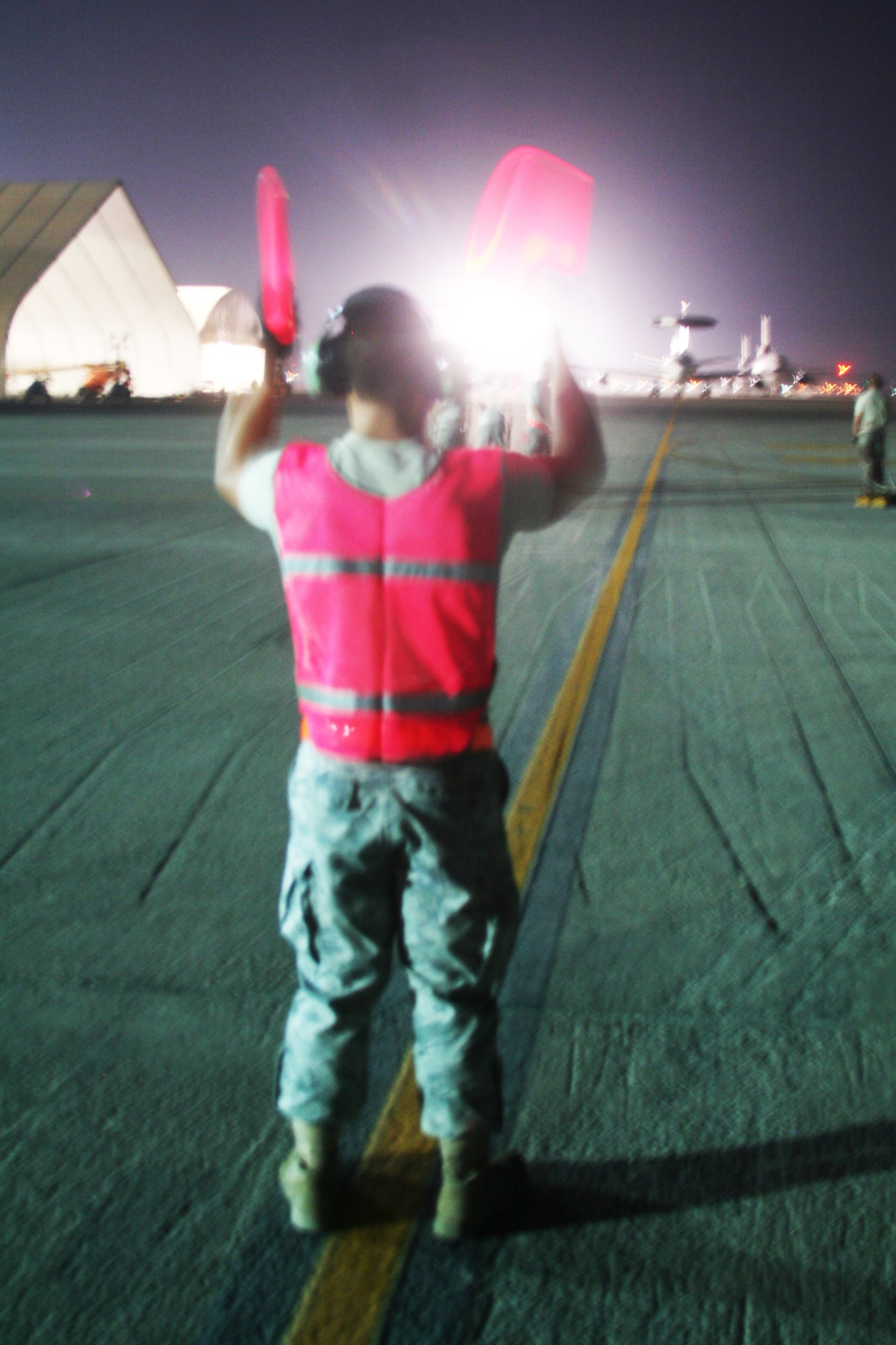 A maintenance Airman from the 380th Expeditionary Aircraft Maintenance Squadron Sentry aircraft maintenance unit uses light sticks to guide an E-3 Sentry Airborne Warning and Control System aircraft to a parking spot on the flightline during operations for the 380th Air Expeditionary Wing at a non-disclosed base in Southwest Asia on May 19, 2010. The E-3 aircraft and the Airmen who support them are deployed from the 552nd Air Control Wing at Tinker Air Force Base, Okla. (U.S. Air Force Photo/Master Sgt. Scott T. Sturkol/Released)