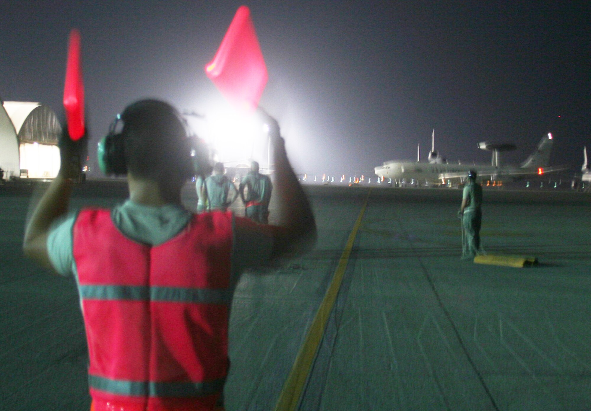 A maintenance Airman from the 380th Expeditionary Aircraft Maintenance Squadron Sentry aircraft maintenance unit uses light sticks to guide an E-3 Sentry Airborne Warning and Control System aircraft to a parking spot on the flightline during operations for the 380th Air Expeditionary Wing at a non-disclosed base in Southwest Asia on May 19, 2010. The E-3 aircraft and the Airmen who support them are deployed from the 552nd Air Control Wing at Tinker Air Force Base, Okla. (U.S. Air Force Photo/Master Sgt. Scott T. Sturkol/Released)