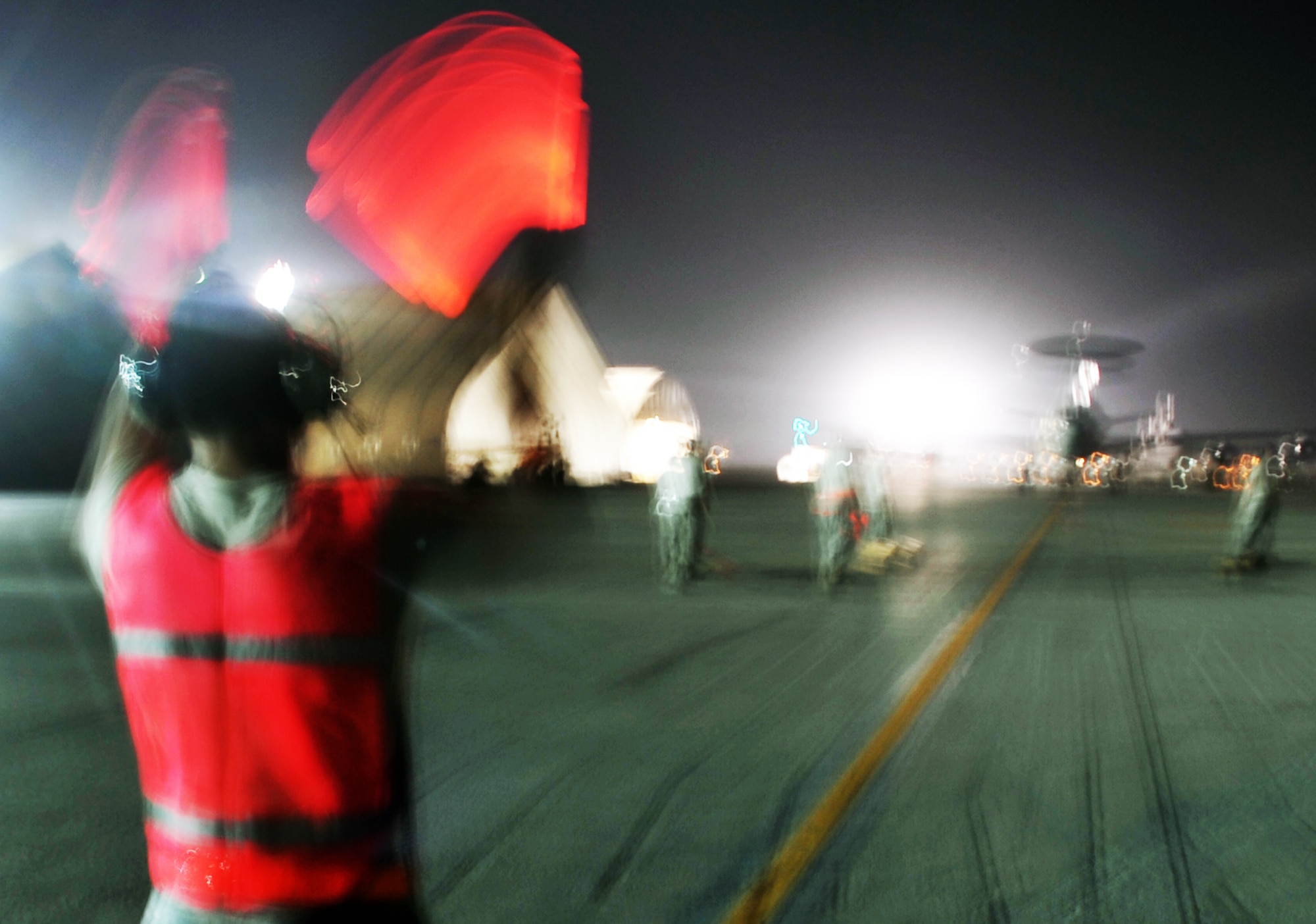 A maintenance Airman from the 380th Expeditionary Aircraft Maintenance Squadron Sentry aircraft maintenance unit uses light sticks to guide an E-3 Sentry Airborne Warning and Control System aircraft to a parking spot on the flightline during operations for the 380th Air Expeditionary Wing at a non-disclosed base in Southwest Asia on May 19, 2010. The E-3 aircraft and the Airmen who support them are deployed from the 552nd Air Control Wing at Tinker Air Force Base, Okla. (U.S. Air Force Photo/Master Sgt. Scott T. Sturkol/Released)