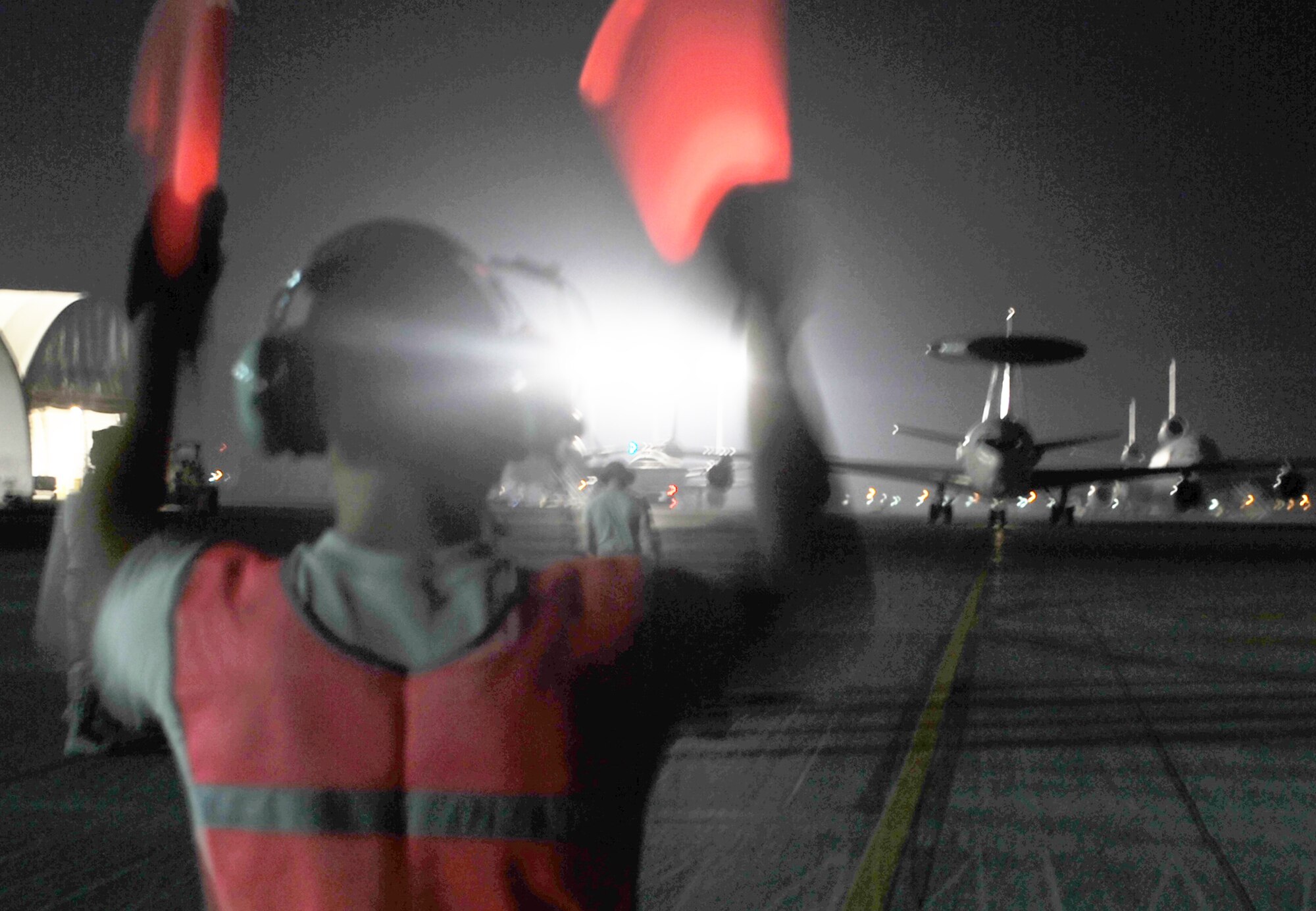 A maintenance Airman from the 380th Expeditionary Aircraft Maintenance Squadron Sentry aircraft maintenance unit uses light sticks to guide an E-3 Sentry Airborne Warning and Control System aircraft to a parking spot on the flightline during operations for the 380th Air Expeditionary Wing at a non-disclosed base in Southwest Asia on May 19, 2010. The E-3 aircraft and the Airmen who support them are deployed from the 552nd Air Control Wing at Tinker Air Force Base, Okla. (U.S. Air Force Photo/Master Sgt. Scott T. Sturkol/Released)