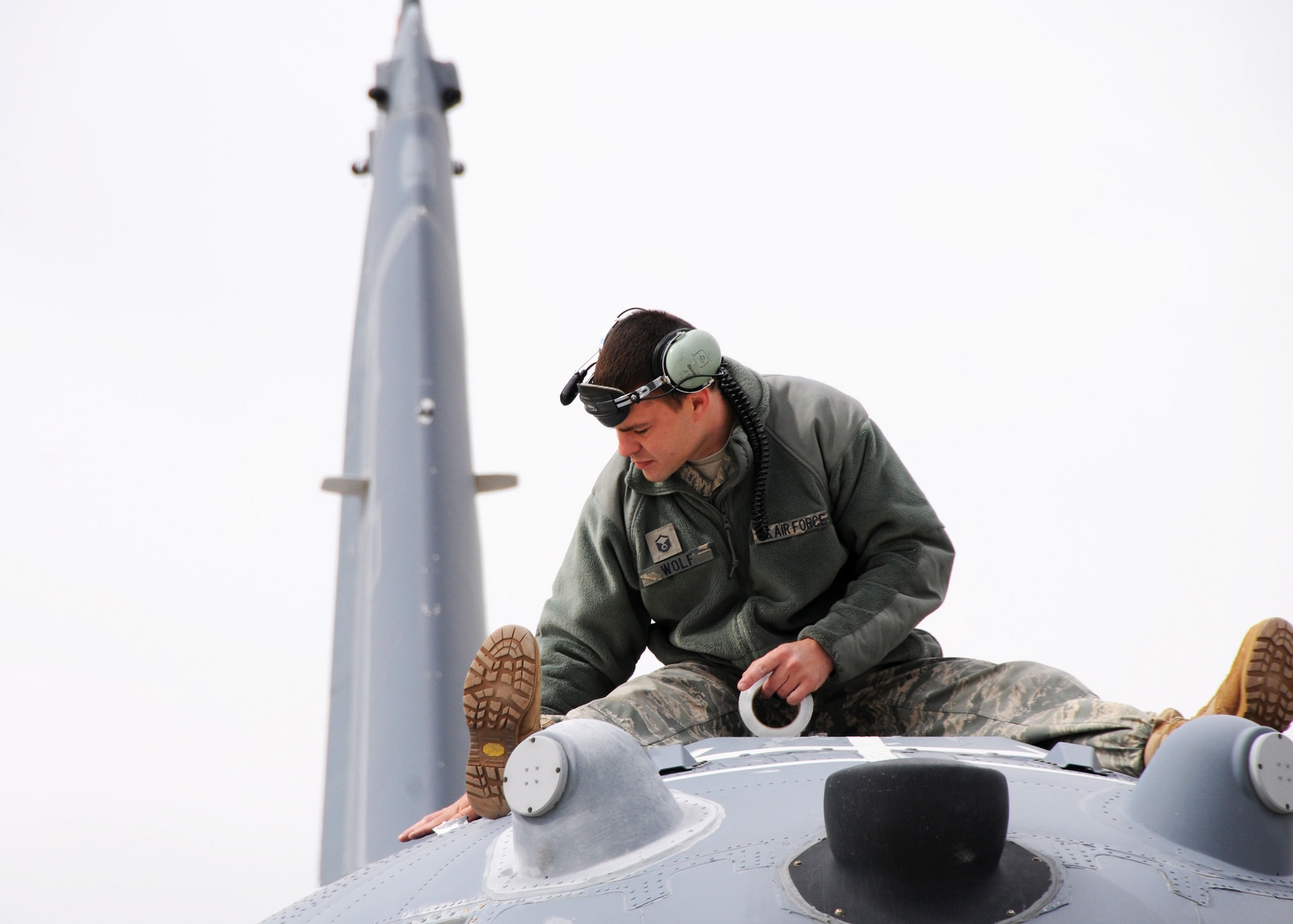 Master Sgt. Kris Wolf, 179th Maintenance Group, applies tape to the top a MC-130E Combat Talon May 5 at Gowen Field, Idaho.  919th, along with the 179th were sent to Boise, Idaho, to prepare four Talons to take off for one more mission – a flight into retirement and decommissioning.  Three of the Talons flew to Davis-Monthan Air Force Base, Ariz.  The other went to Hurlburt Field, Fla., to be placed in the Air Force Special Operations Command airpark.  (U.S. Air Force photo/Tech. Sgt. Samuel King Jr.)  