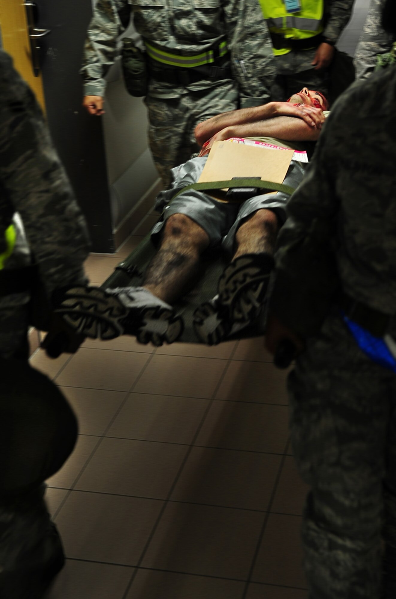 U.S. Air Force members of the 86th Medical Group, rush the victim of a simulated rocket attack to 'triage' during an operational readiness exercise, Ramstein Air Base, Germany, May 22, 2010. The exercise is being conducted to prepare for an up-coming operational readiness inspection. (U.S. Air Force photo by Senior Airmen Tony R. Ritter) 