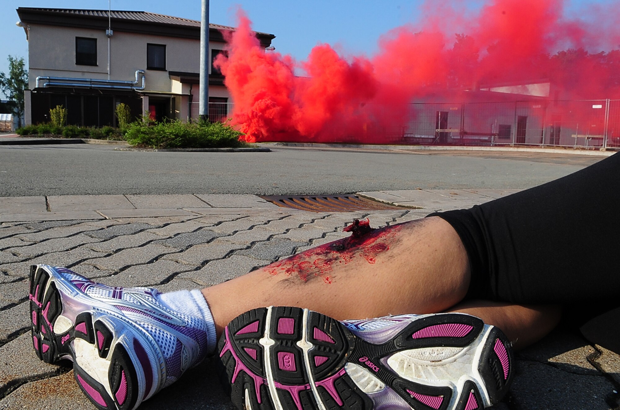 The victim of a simulated rocket attack lies injured, waiting to be recovered and treated during an operational readiness exercise, Ramstein Air Base, Germany, May 22, 2010. The exercise is being conducted to prepare for an up-coming operational readiness inspection. (U.S. Air Force photo by Senior Airmen Tony R. Ritter) 