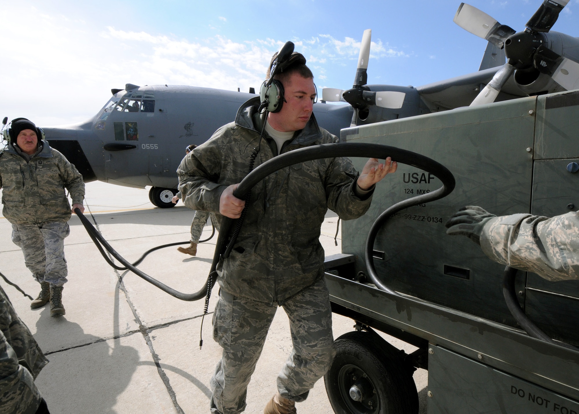 Staff Sgt. Travis Hooper, 179th Maintenance Group, and Senior Master Sgt. William McAnelly, 919th Maintenance Group, brings back the power cable from MC-130E Combat Talon #555 prior to its final flight May 5 from Gowen Field, Idaho.  919th, along with the 179th were sent to Boise, Idaho, to prepare four Talons to take off for one more mission – a flight into retirement and decommissioning.  Three of the Talons flew to Davis-Monthan Air Force Base, Ariz.  The other went to Hurlburt Field, Fla., to be placed in the Air Force Special Operations Command airpark.  (U.S. Air Force photo/Tech. Sgt. Samuel King Jr.)  