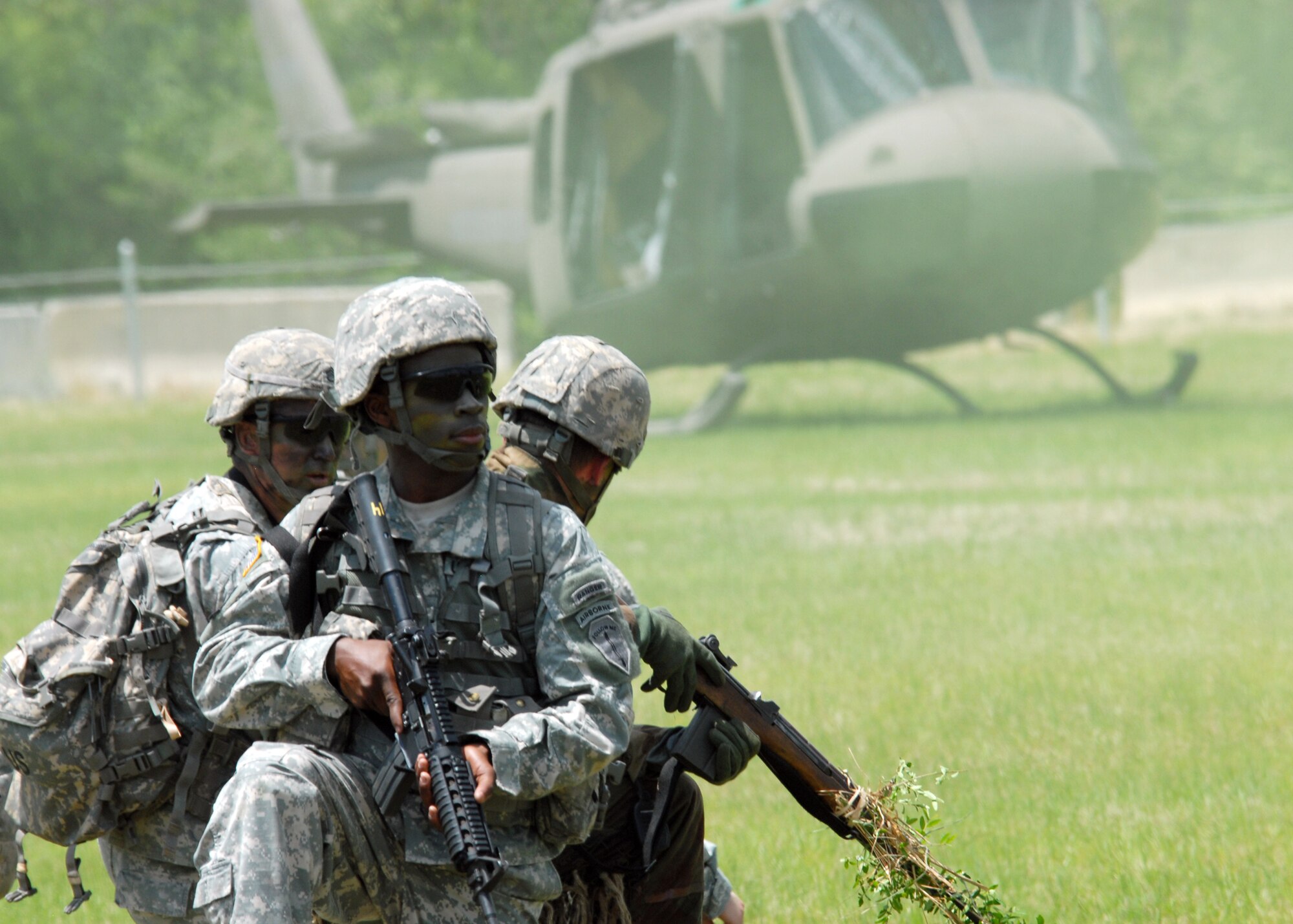 Rangers wait for the helicopter to arrive before moving the injured during the Ranger Open House May 22.  The event was a chance for the public to learn how Rangers train and operate in extreme situations. The event displays such as dive equipment, weapons, and zodiac boats and demonstrations like hand-to-hand combat, parachute jump, and an urban operations demonstration.  (U.S. Air Force photo/Samuel King Jr.)