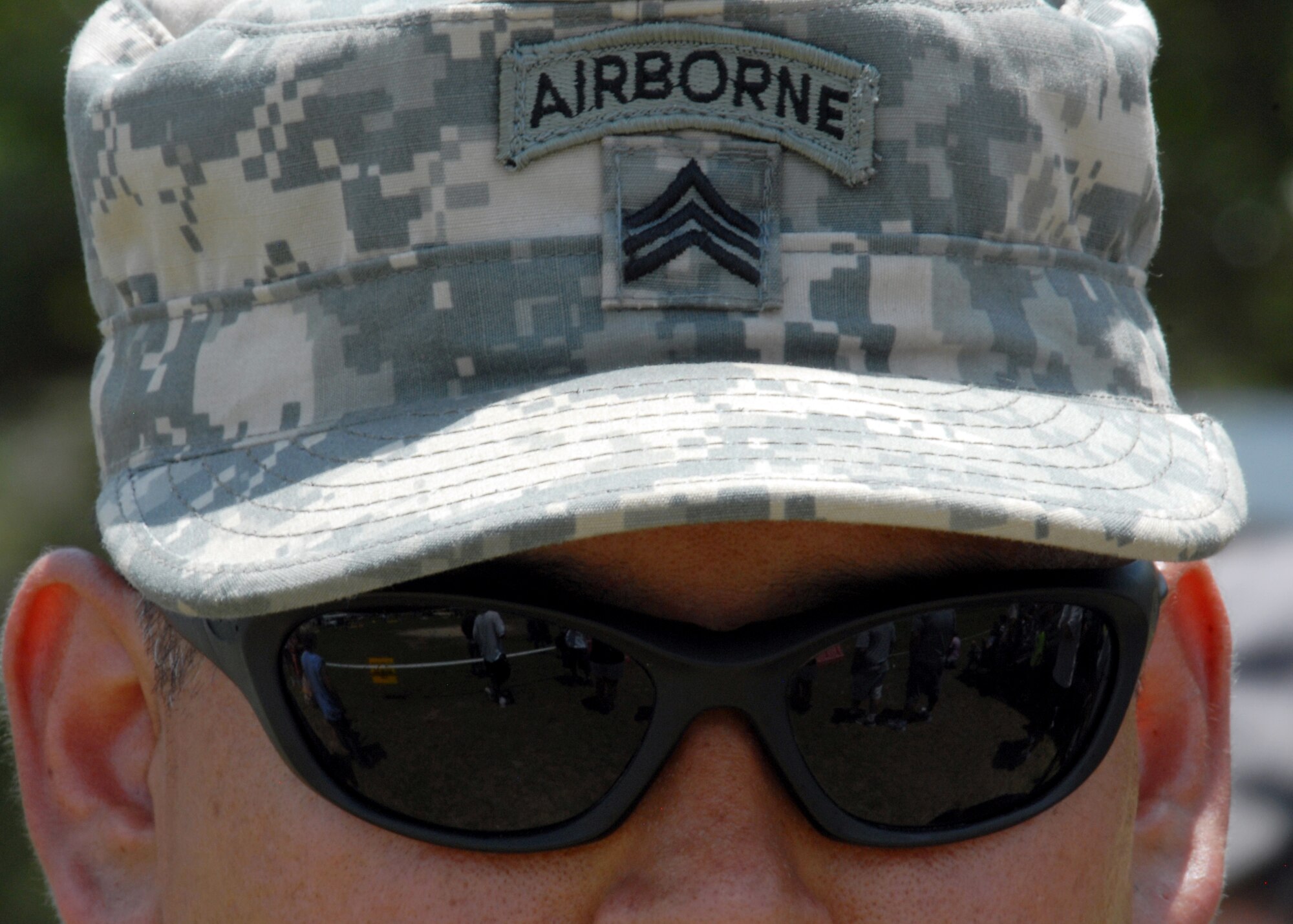 An Army Ranger sergeant watches the demonstrations during the Ranger Open House May 22.  The event was a chance for the public to learn how Rangers train and operate in extreme situations. The event displays such as dive equipment, weapons, and zodiac boats and demonstrations like hand-to-hand combat, parachute jump, and an urban operations demonstration.  (U.S. Air Force photo/Samuel King Jr.)