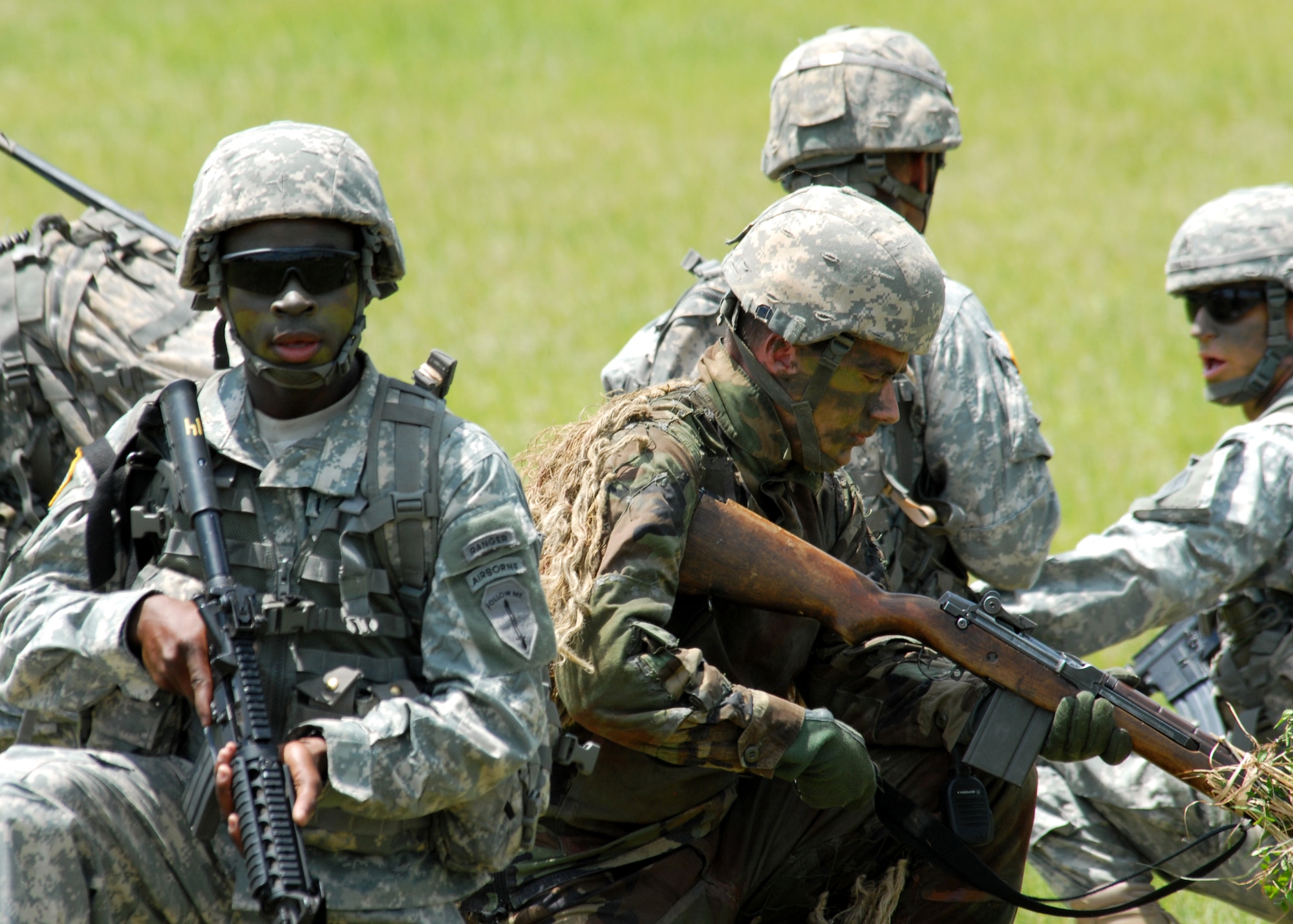 Rangers guard their injured while waiting on the helicopter to arrive during a downed pilot demonstration at the 6th Ranger Training Battalion Open House May 22.  The event was a chance for the public to learn how Rangers train and operate in extreme situations. The event displays such as dive equipment, weapons, and zodiac boats and demonstrations like hand-to-hand combat, parachute jump, and an urban operations demonstration.  (U.S. Air Force photo/Samuel King Jr.)