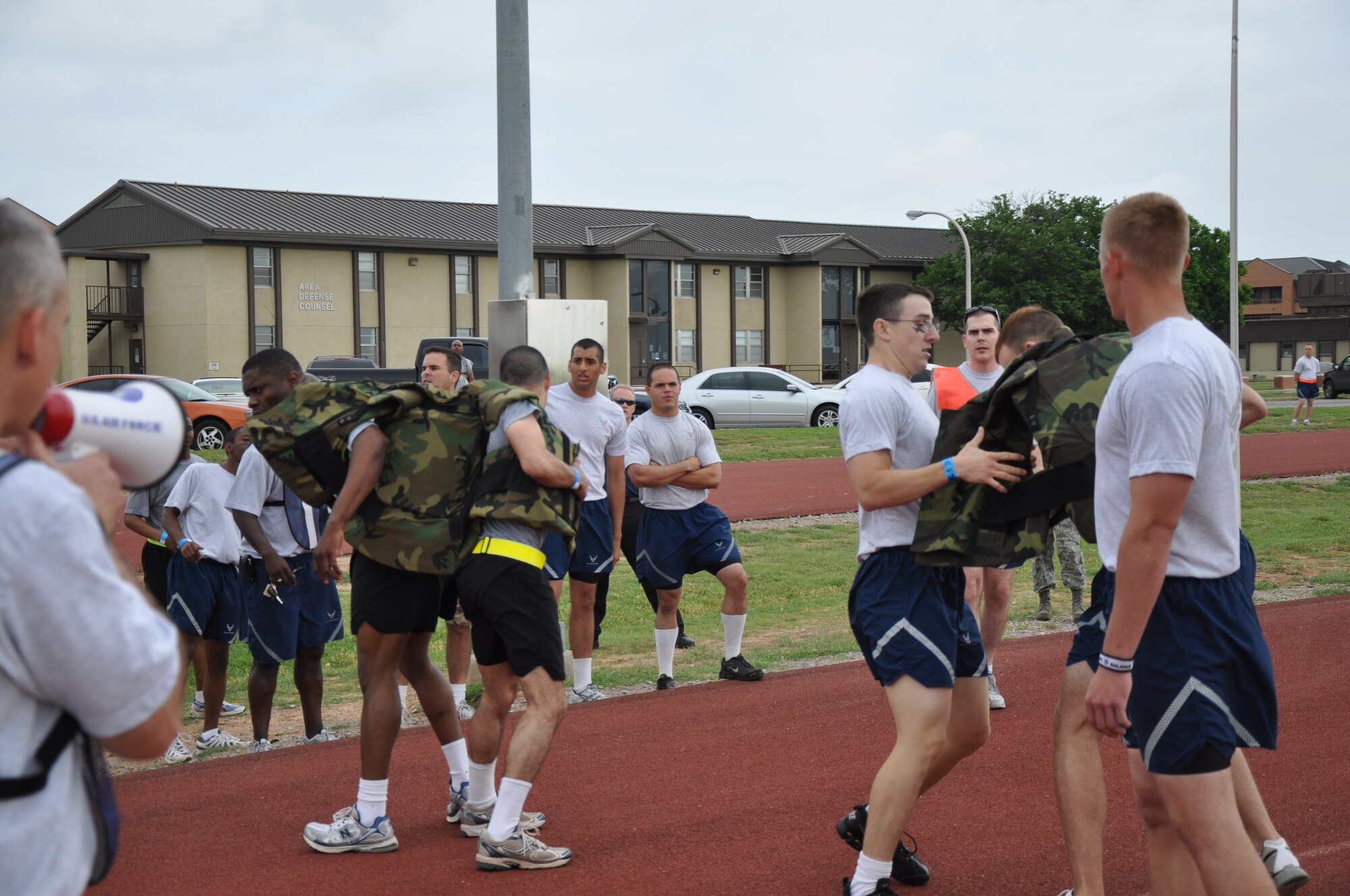 The Army team uses a relay method that involves one runner putting on the heavy-plated vest at the same time the other one is taking it off at the Joint Warrior Challenge at Sheppard's one-mile track May 22, 2010.  Joint Warrior Challenge was a physical competition which consisted of an armor-plated relay race, a litter-carry race, a tire flipping race and a tug of war.  (U.S. Air Force photo/Airman 1st Class Adawn Kelsey)
