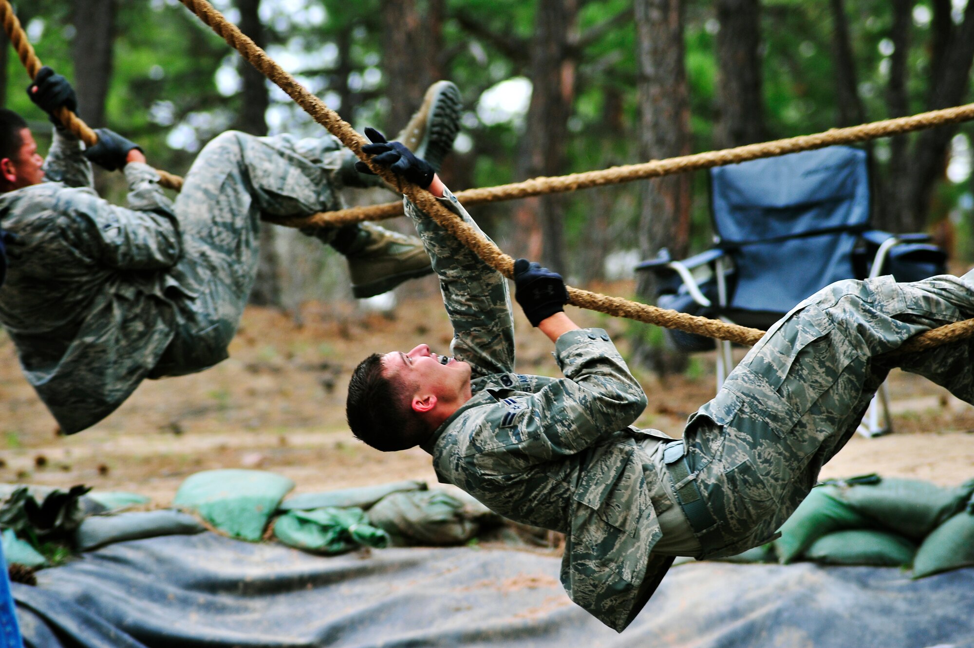 U.S. AIR FORCE ACADEMY, Colo. -- Airman 1st Class Christopher Uremovich, 460th Security Forces Squadron, pulls himself hand over hand across a water hole during the Air Force Space Command Guardian Challenge 2010. Airman Uremovich is one Team Buckley's four Security Forces team members to face the course. (U.S. Air Force photo by Staff Sgt. Kathrine McDowell)