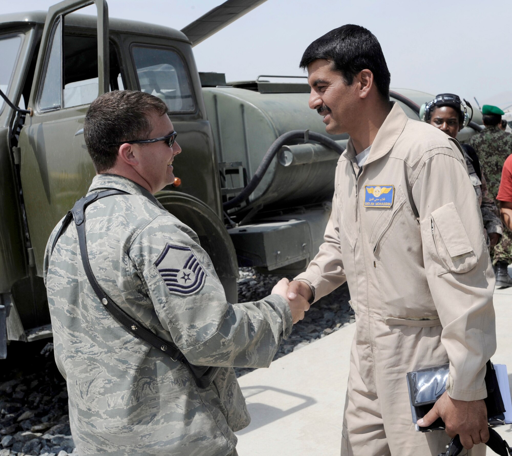 Master Sgt. Raymond Rogers greets Afghanistan National Army Air Corps Capt. Gholam Mohaiudin prior to a training mission May 15, 2010, at Kabul International Airport, Aghanistan. Sergeant Rogers is a 438th Air Expeditionary Advisory Squadron armament and ammunition flight adviser and Lieutenant  Mohaiudin is a  Mi-35 Hind E helicopter pilot. (U.S. Air Force photo/Tech. Sgt. Oshawn Jefferson)