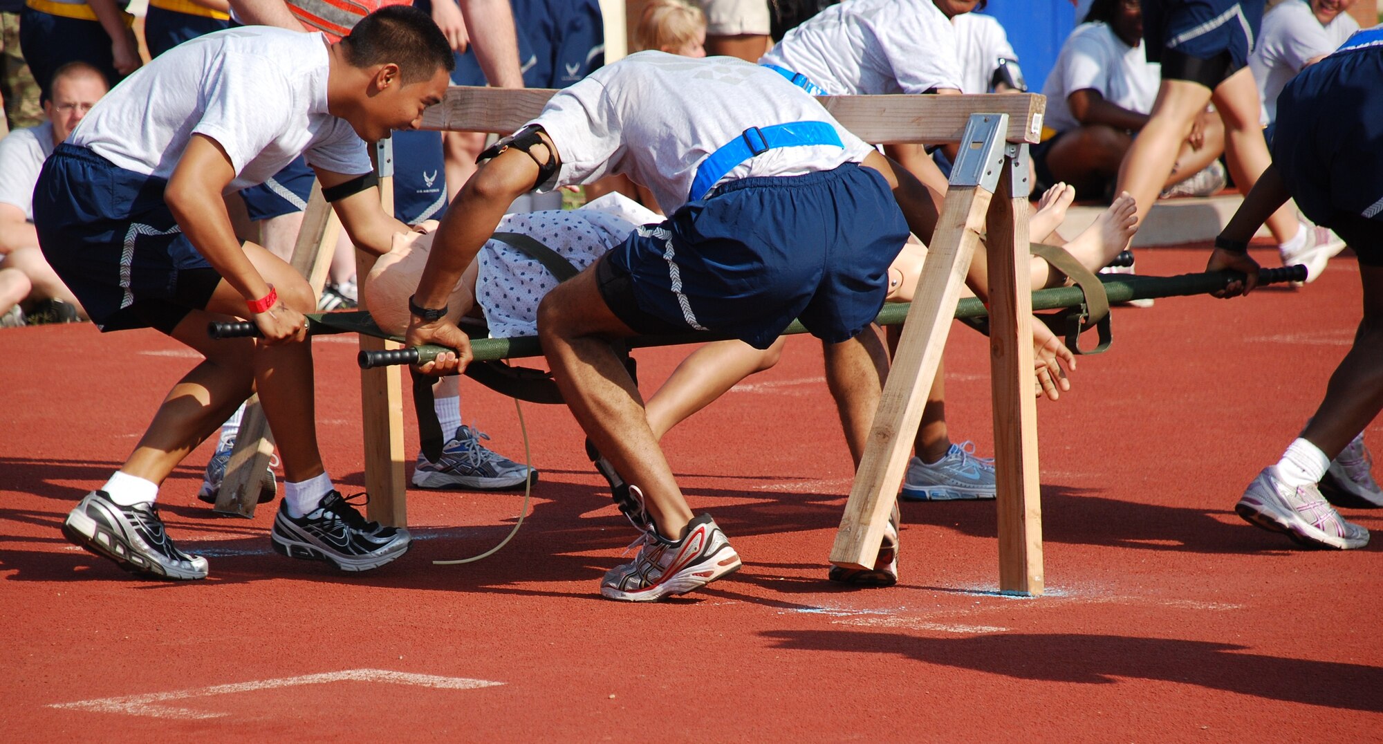 Airmen in Training negotiate the obstacle in the Litter Race as they compete for points in the Joint Warrior Challenge at the one-mile track May 22, 2010.  Joint Warrior Challenge was a physical competition consisting of an armor-plated relay race, a litter-carry race, a tire flipping race and a tug of war.  (U.S. Air Force photo/Tech. Sgt. Vernon Cunningham)