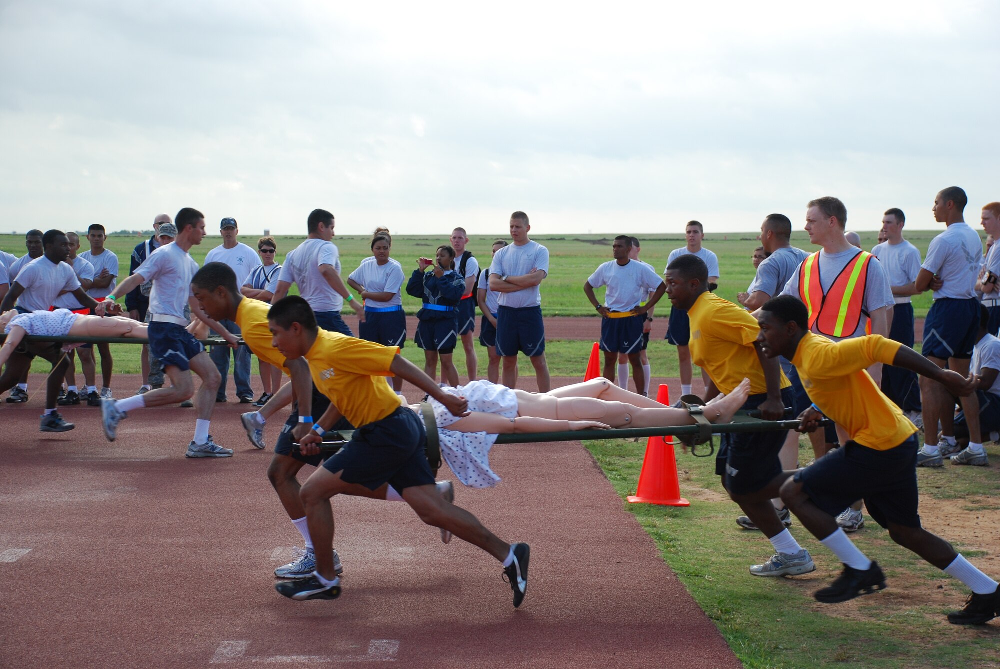 The Navy team sprints across the playing field as they compete in the Joint Warrior Challenge Litter Race at the one-mile track May 22, 2010. Joint Warrior Challenge was a physical competition consisting of an armor-plated relay race, a litter-carry race, a tire flipping race and a tug of war.  (U.S. Air Force photo/Tech. Sgt. Vernon Cunningham)
