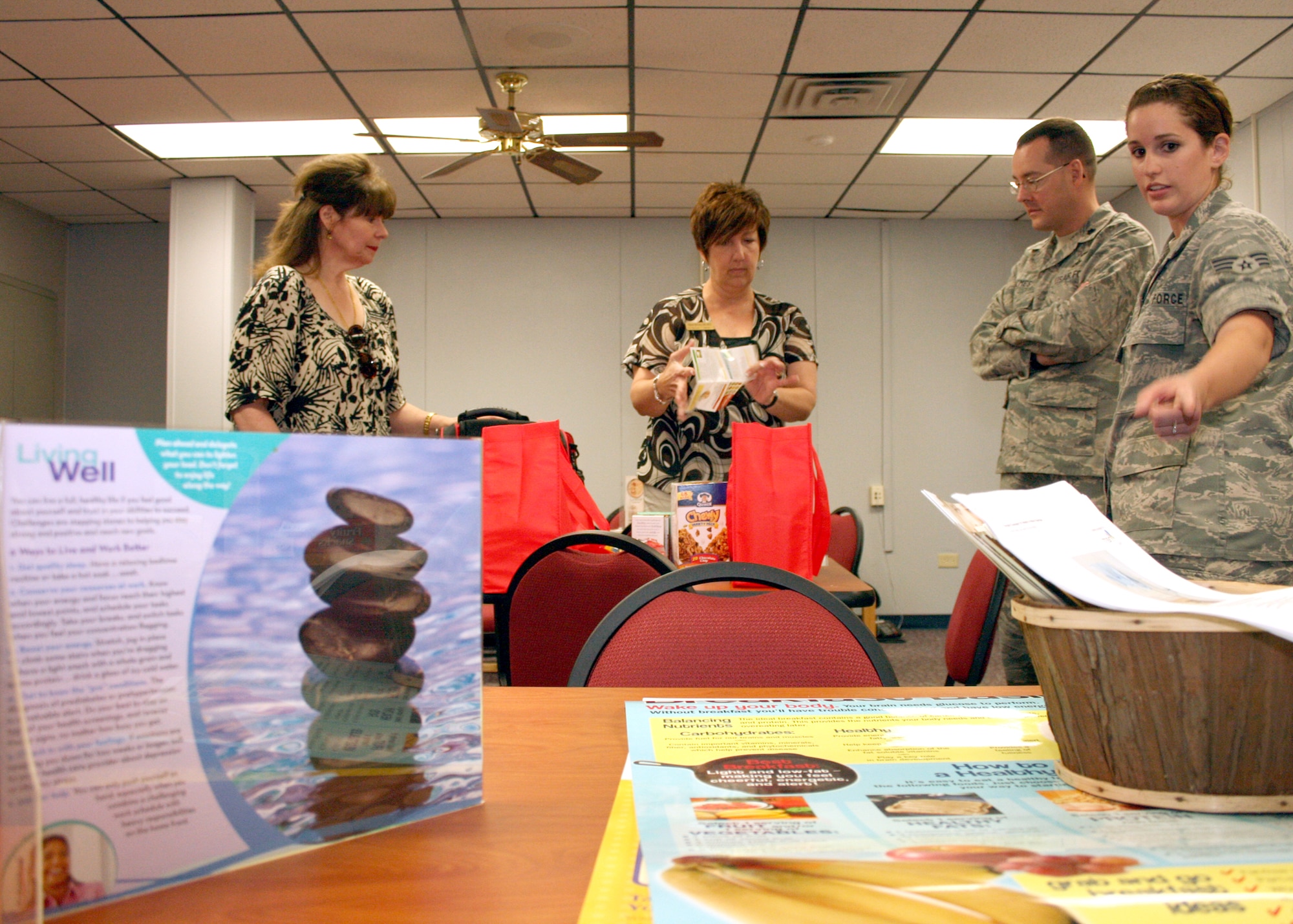 EGLIN AIR FORCE BASE, Fla. - Alison DeCaro and Marilyn Leggett from the Eglin Health and Wellness Center explain healthy snack choices to 96th Logistic Readiness Squadron member Senior Airman Ashley O'Brien. The HAWC helped the 96th LRS makeover their snack bar in an effort to provide healthy snacks to the unit. This move to create a healthy nutritional environment follows the direction set by the Air Force to improve health and fitness in its forces. (U.S. Air Force photo by 2nd Lt. Andrew Caulk)