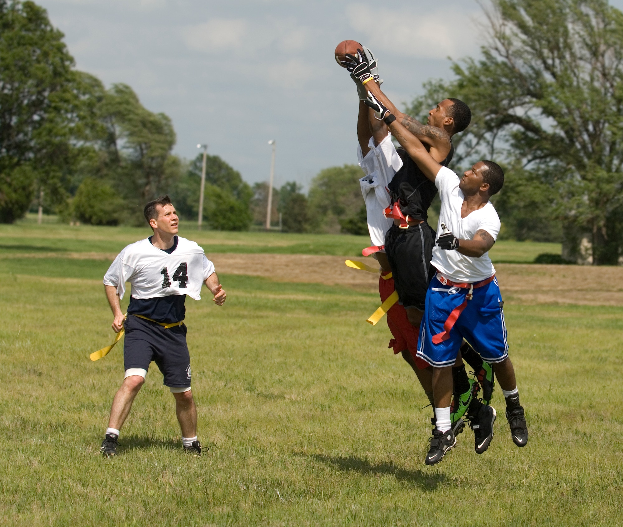 Col. Jamie Crowhurst, 22nd Air Refueling Wing commander, reacts as his teammates battle to catch a ball during the 2010 NCAA Coaches Tour flag football game at the Krueger Recreational Area May 22, 2010, McConnell Air Force Base, Kan. McConnell kicked off the 2010 NCAA Coaches Tour. The base commanders defeated the base chiefs and first sergeants, 14 to 7. (U.S. Air Force photo/Airman Armando A. Schwier-Morales)