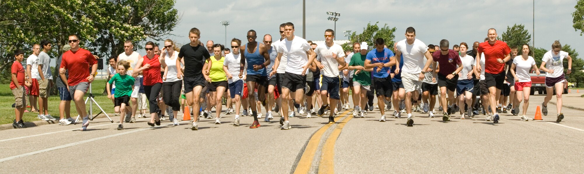 Team McConnell members participate in the 2010 NCAA Coaches Tour 5k run at the Krueger Recreational Area May 22, 2010, McConnell Air Force Base, Kan. McConnell kicked off the 2010 Coaches Tour with a 5K run, a burger burn, autograph session and a flag football game. A 22nd Air Refueling Wing KC-135 Stratotanker took Harvard head coach Tim Murphy, Oregon head coach Chip Kelly, Illinois head coach Ron Zook and West Point head coach Rich Ellerson on an eight-day tour to visit servicemembers serving in Europe and Southwest Asia. This is the third time McConnell has hosted the tour. (U.S. Air Force photo/Airman Armando A. Schwier-Morales)