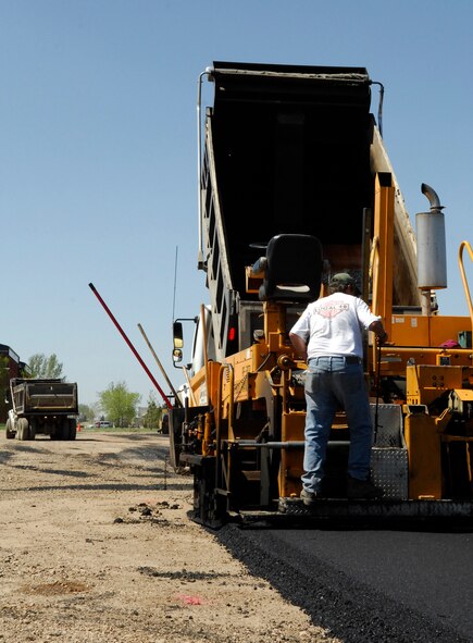 MINOT AIR FORCE BASE, N.D. – Contractor Brad Lee stands on a paver in the J.R. Rockers parking lot here May 20.  Lee is working with the 5th Civil Engineer Squadron on an overhaul project of the parking lot.  This is just one of many construction projects on base this summer.  (U.S. Air Force photo by Staff Sgt. Miguel Lara III)