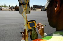MINOT AIR FORCE BASE, N.D. – Senior Airman Pasha Hughes, 5th Civil Engineer Squadron engineering assistant specialist, checks the data on his TSC2 R-7 in the J.R. Rockers parking lot here May 20.  The parking lot overhaul is just one of many construction projects on base this summer.  (U.S. Air Force photo by Staff Sgt. Miguel Lara III)