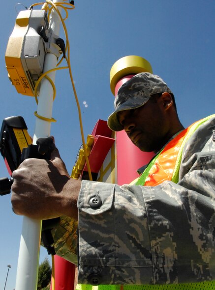 MINOT AIR FORCE BASE, N.D. – Senior Airman Pasha Hughes, 5th Civil Engineer Squadron engineering assistant specialist, uses a TSC2 R-7 to survey the curves and sidewalk in the J. R. Rockers parking lot here May 20.   The parking lot overhaul is just one of many construction projects on base this summer.  (U.S. Air Force photo by Staff Sgt. Miguel Lara III)