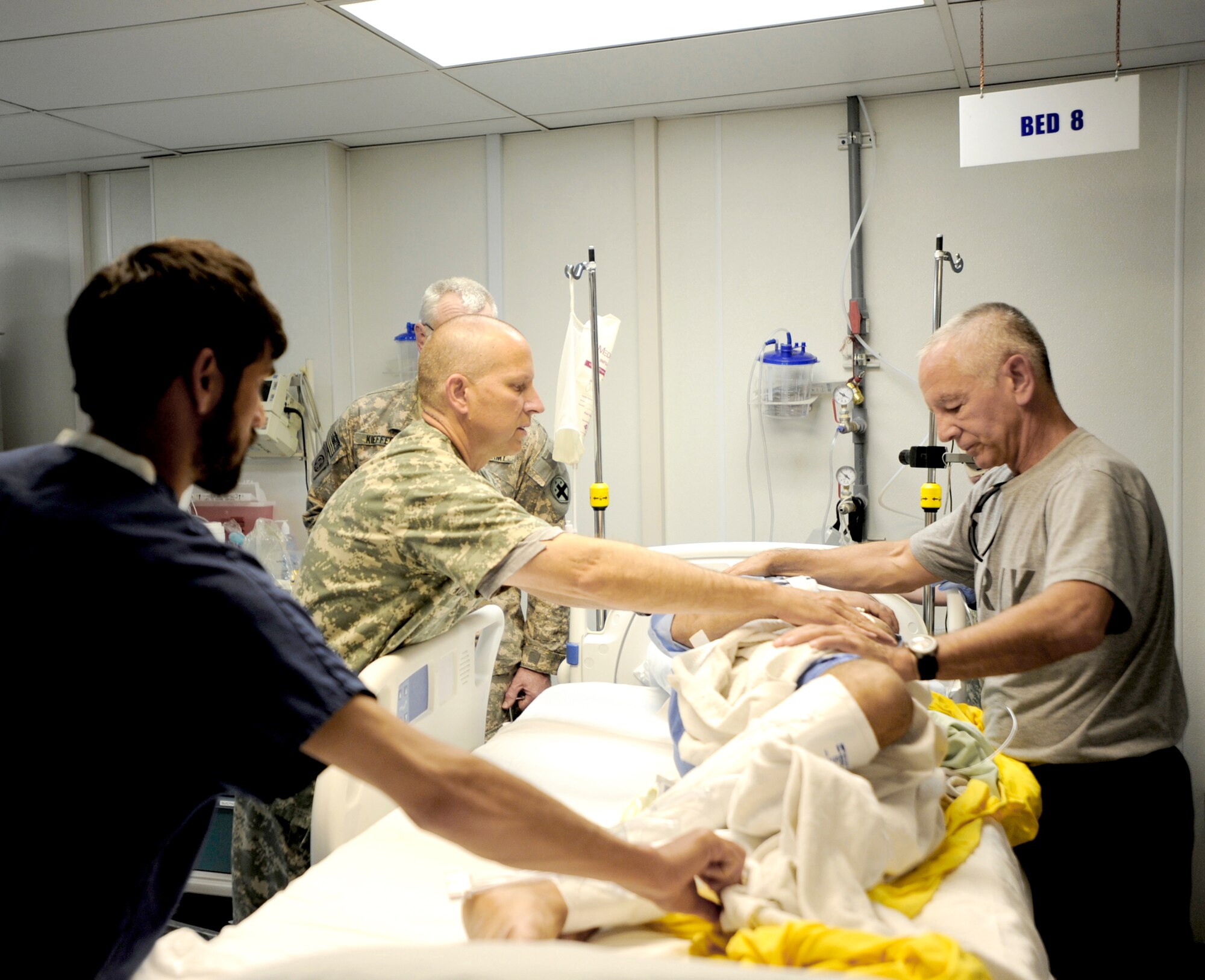 Army Capt. Andrew Kontowicz (left) and Army Lt. Col. (Dr.) Davis Williams with the help of an Afghan nurse conduct an assessment of a patient medically evacuated from the Craig Joint Theater Hospital at Bagram Airfield May 12, 2010, to Forward Operating Base Salerno, Afghanistan. (U.S. Air Force photo/Staff Sgt. Manuel J. Martinez)