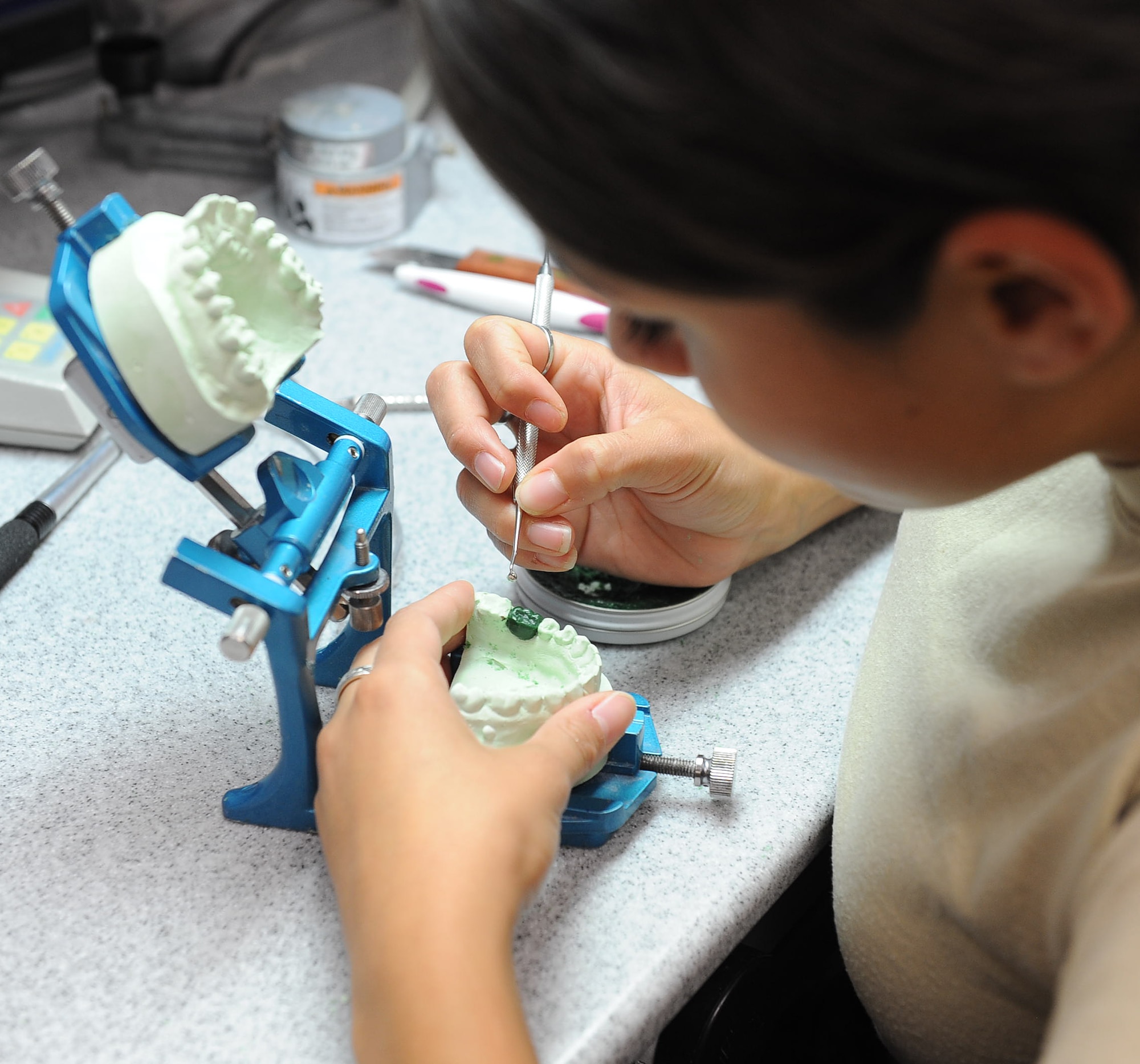 LANGLEY AIR FORCE BASE, Va. -- Airman Alyssa Carrillo, 633d Dental Squadron laboratory technician, fabricates a crown on a dental impression May 6.  Boasting a 31-room facility and a satellite clinic within the base’s main hospital, the 633 DS provides world-class care in all areas of general dentistry to more than 37,000 patients annually. (U.S. Air Force photo/Airman 1st Class Gul Crockett)