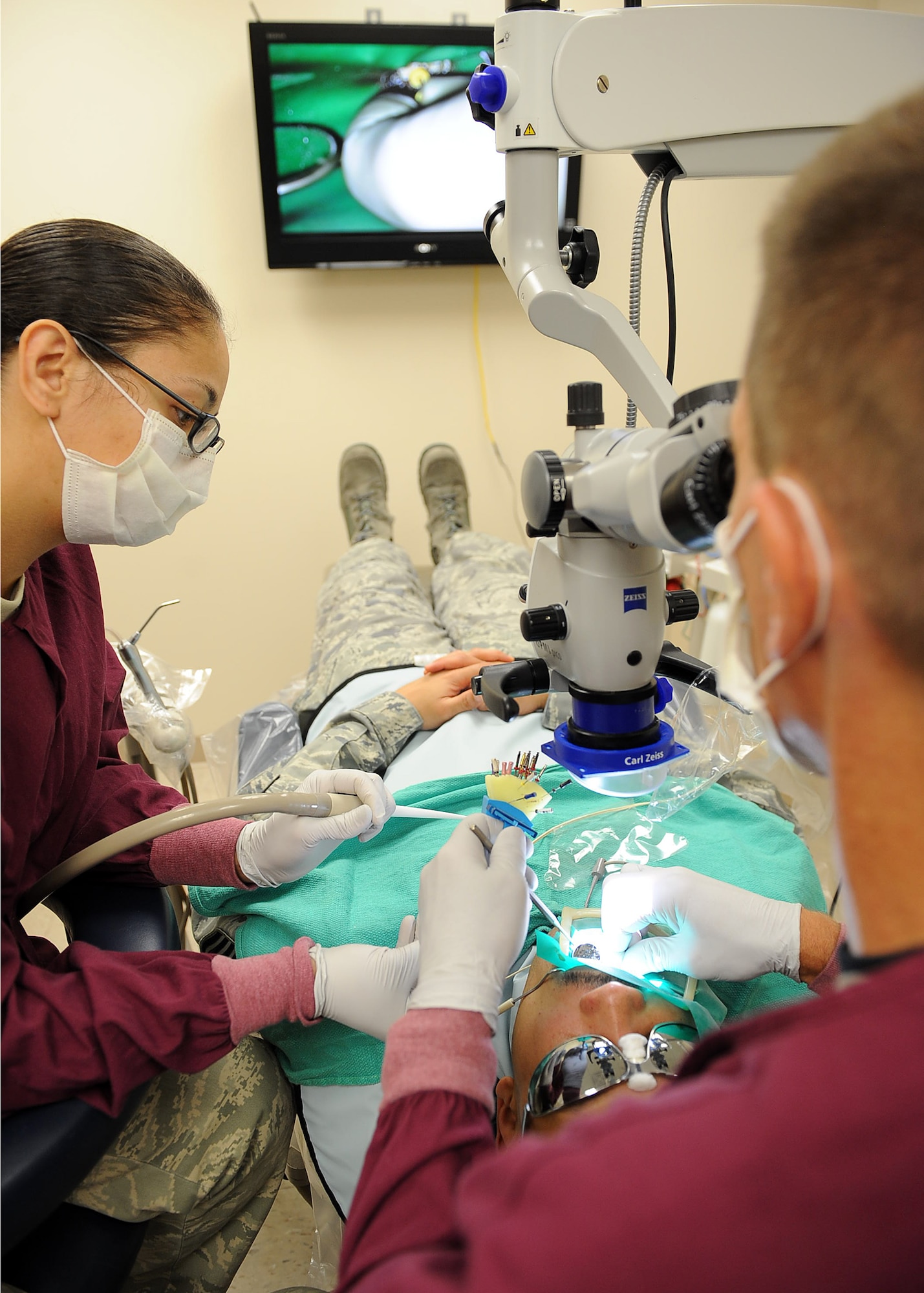 LANGLEY AIR FORCE BASE, Va. -- Staff Sgt. Laloni Butehcer, 633d Dental Squadron dental technician, assists Dr. Lee Fulsaas, 633 DS dental surgeon, during a root canal procedure on Senior Master Sgt. Dwayne Menefee, 1st Maintenance Operations Squadron superintendent of maintenance operations flight, May 6. Boasting a 31-room facility and a satellite clinic within the base’s main hospital, the 633 DS provides world-class care in all areas of general dentistry to more than 37,000 patients annually. (U.S. Air Force photo/Airman 1st Class Gul Crockett)