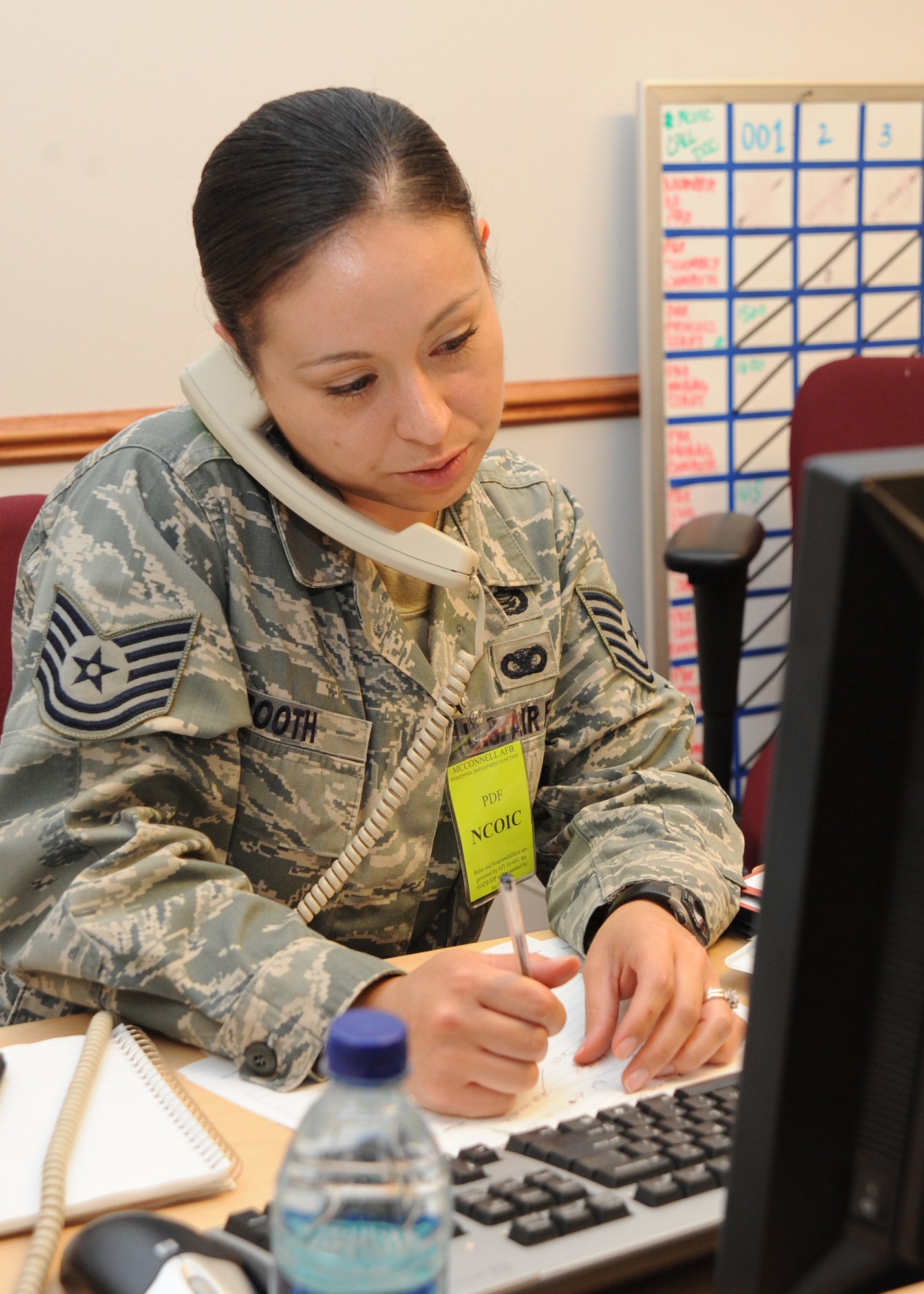 Tech. Sgt. Rosemarie Booth, 22nd Force Support Squadron personnel deployment flight NCOIC, answers telephone calls May 18, 2010, McConnell Air Force Base, Kan.  Airmen are required to have the correct information for pre-deployment documentation to help the process line move more quickly. The exercise included Airmen from almost every unit on base and was conducted to ensure Airmen follow proper procedures in case of real-world short-notice deployments. (U.S. Air Force photo/Airman 1st Class Andrea Salazar)