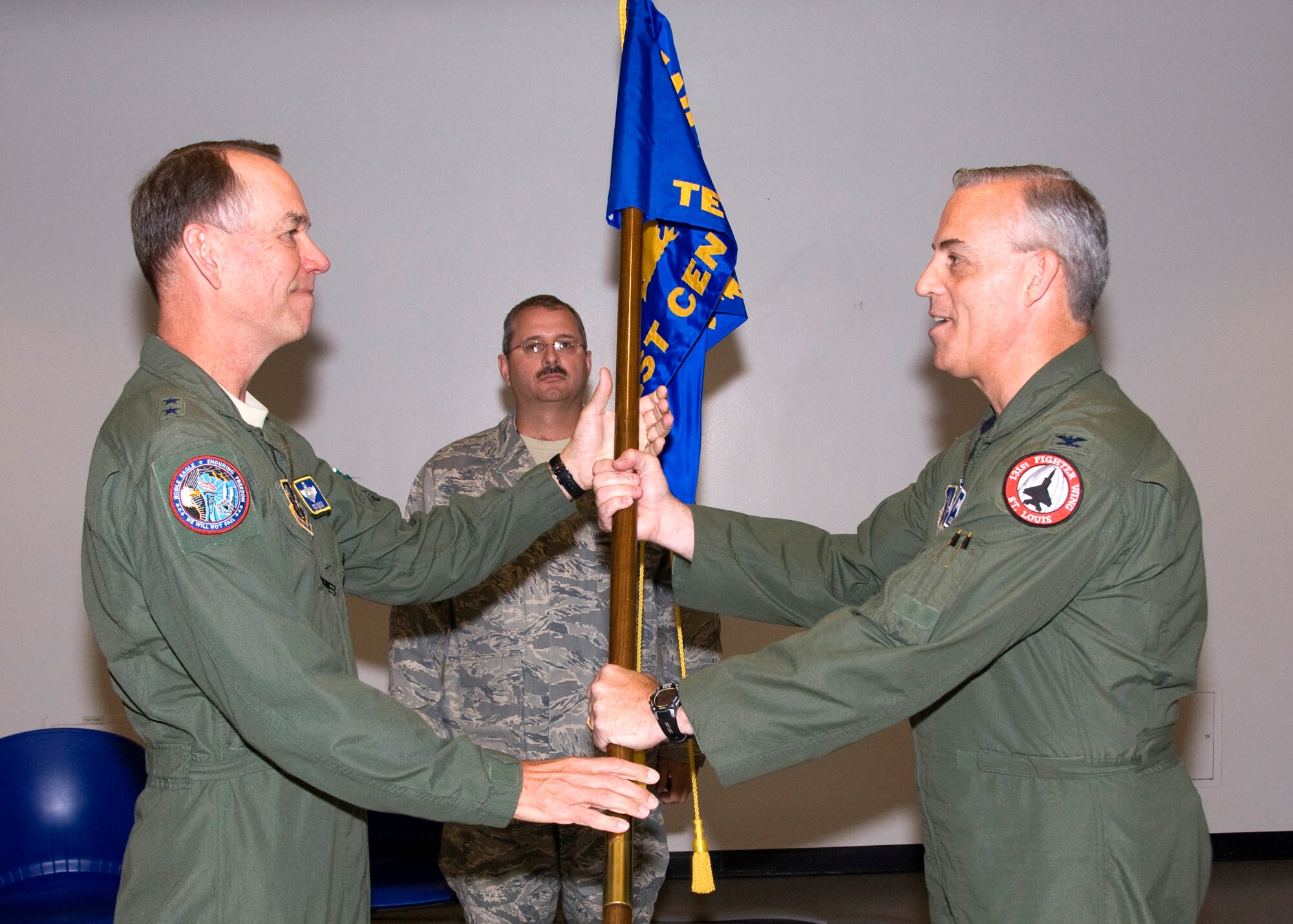 Col. Richard Dennee, right, assumes command of the Air National Guard Air Force Reserve Command Test Center with a symbolic passing of the AATC guideon from Maj. Gen. Rick Moisio, Air National Guard deputy director, May 21. (Air Force photo by Master Sgt. Dave Neve)