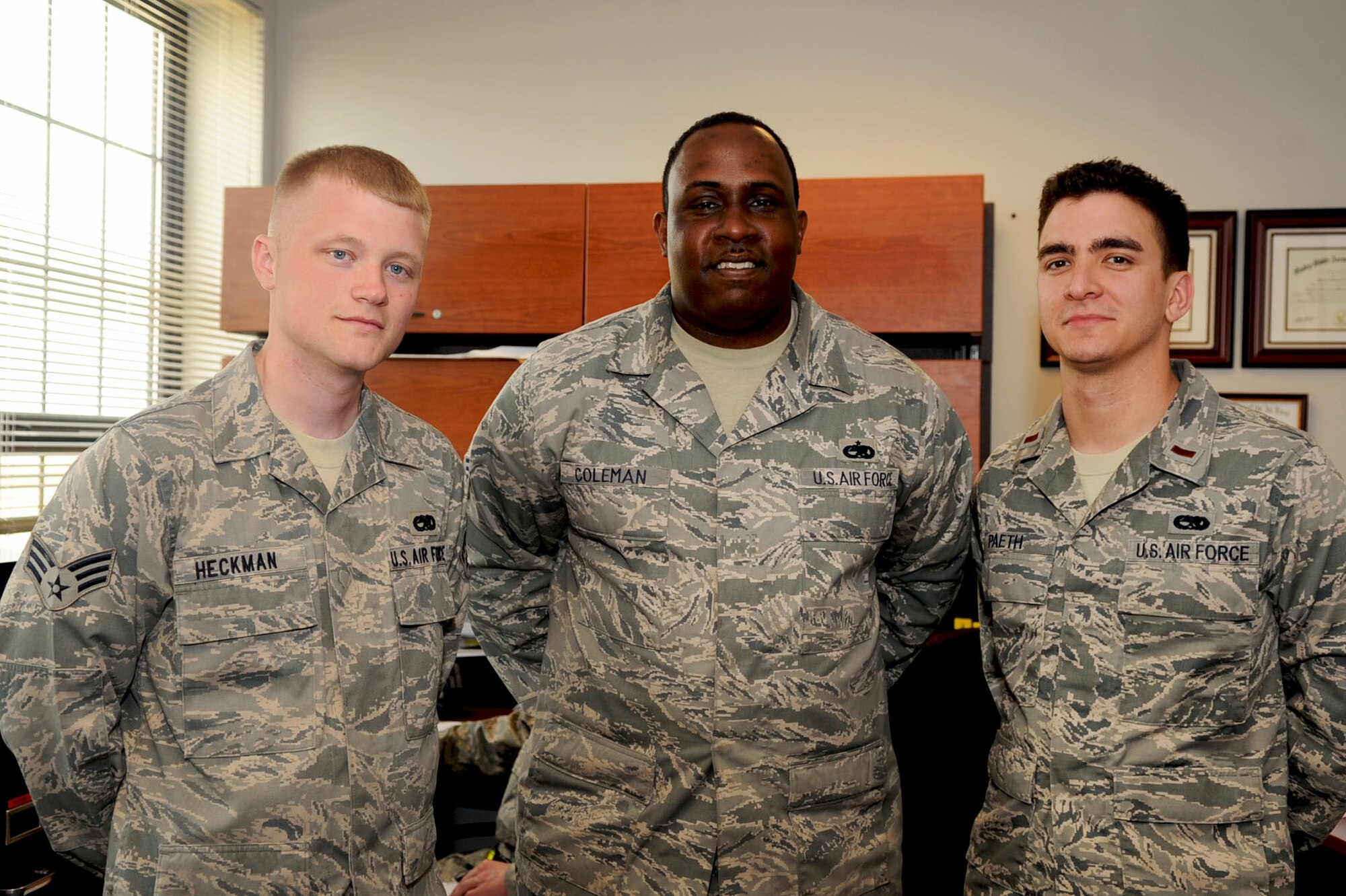 LANGLEY AIR FORCE BASE, Va. -- (From left) Senior Airman Kristopher Heckman, 27th Aircraft Maintenance Unit avionics specialist, Tech. Sgt. James Coleman, 27 AMU specialist section noncommissioned officer in charge, and 2nd Lt. Scott Paeth, 27 AMU assistant officer in charge, pose for a group photo May 12. Heckman’s chain of command supports his decision in pursuing his goals, in both his military and music careers. (U.S. Air Force photo/Staff Sgt. Ashley Hawkins)