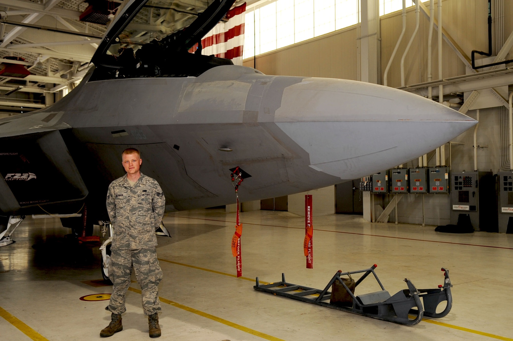 LANGLEY AIR FORCE BASE, Va. -- Senior Airman Kristopher Heckman, 27th Aircraft Maintenance Unit avionics specialist, stands near an F-22 Raptor May 12. Heckman not only maintains equipment for Raptors, but also is a hip-hop musician in his free time. (U.S. Air Force photo/Staff Sgt. Ashley Hawkins) 