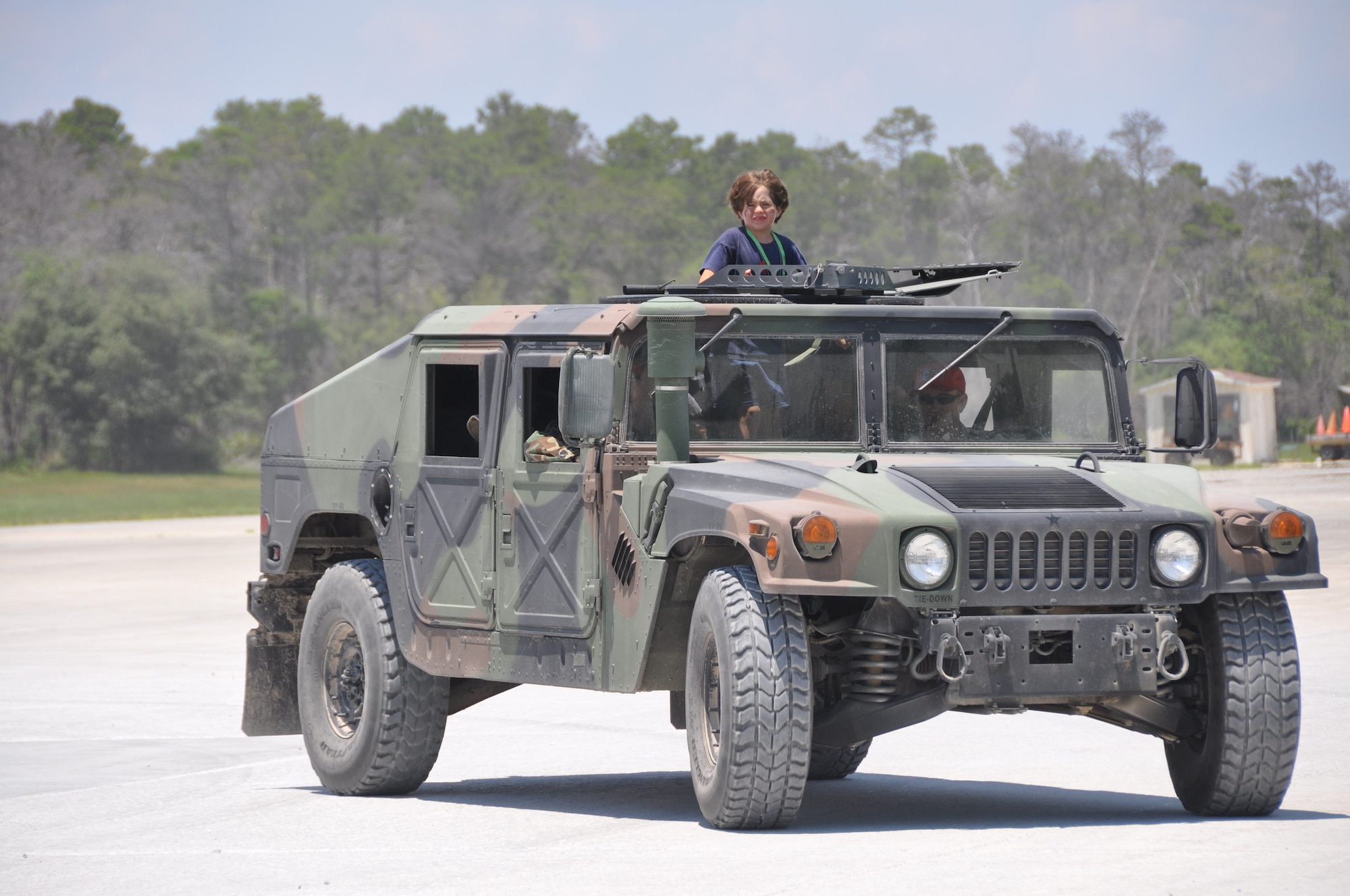 A military dependant rides in a military vehicle May 22 during the Jr. Raptor program. (U.S. Air Force photo by Airman 1st Class Rachelle Elsea)