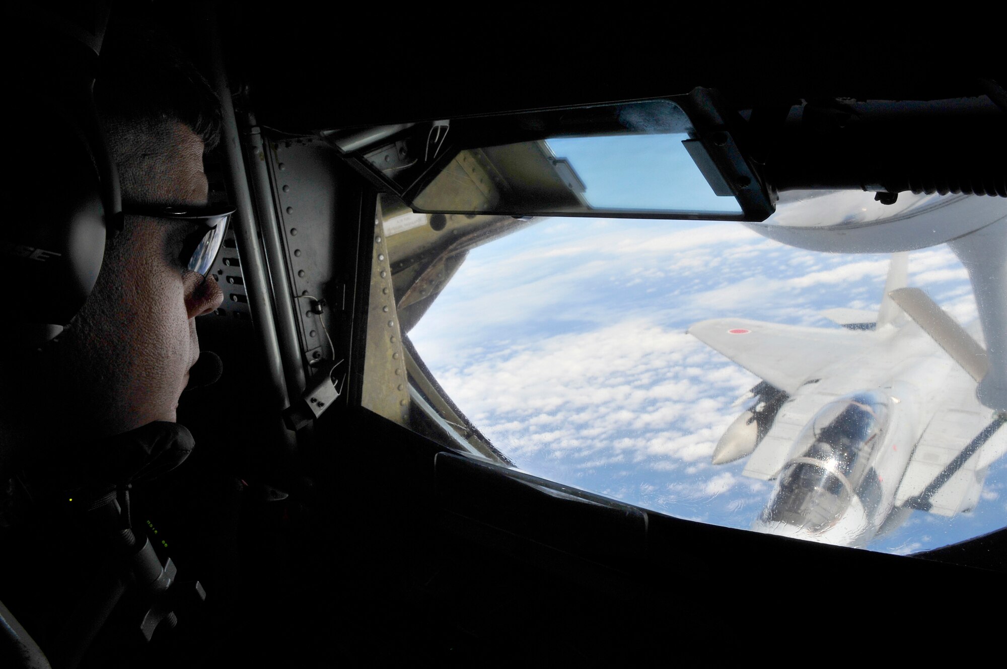 Senior Master Sgt. Michael Steinkraus steers the refueling boom in the back of a KC-135 Stratotanker off loading fuel to a Japan Air Self Defense Force F-15 Eagle during bilateral air refueling training May 17, 2010, at Kadena Air Base, Japan. Sergeant Steinkraus is a boom operator with the 909th Air Refueling Squadron. (U.S. Air Force photo/Tech. Sgt. Chrissy Best) 
