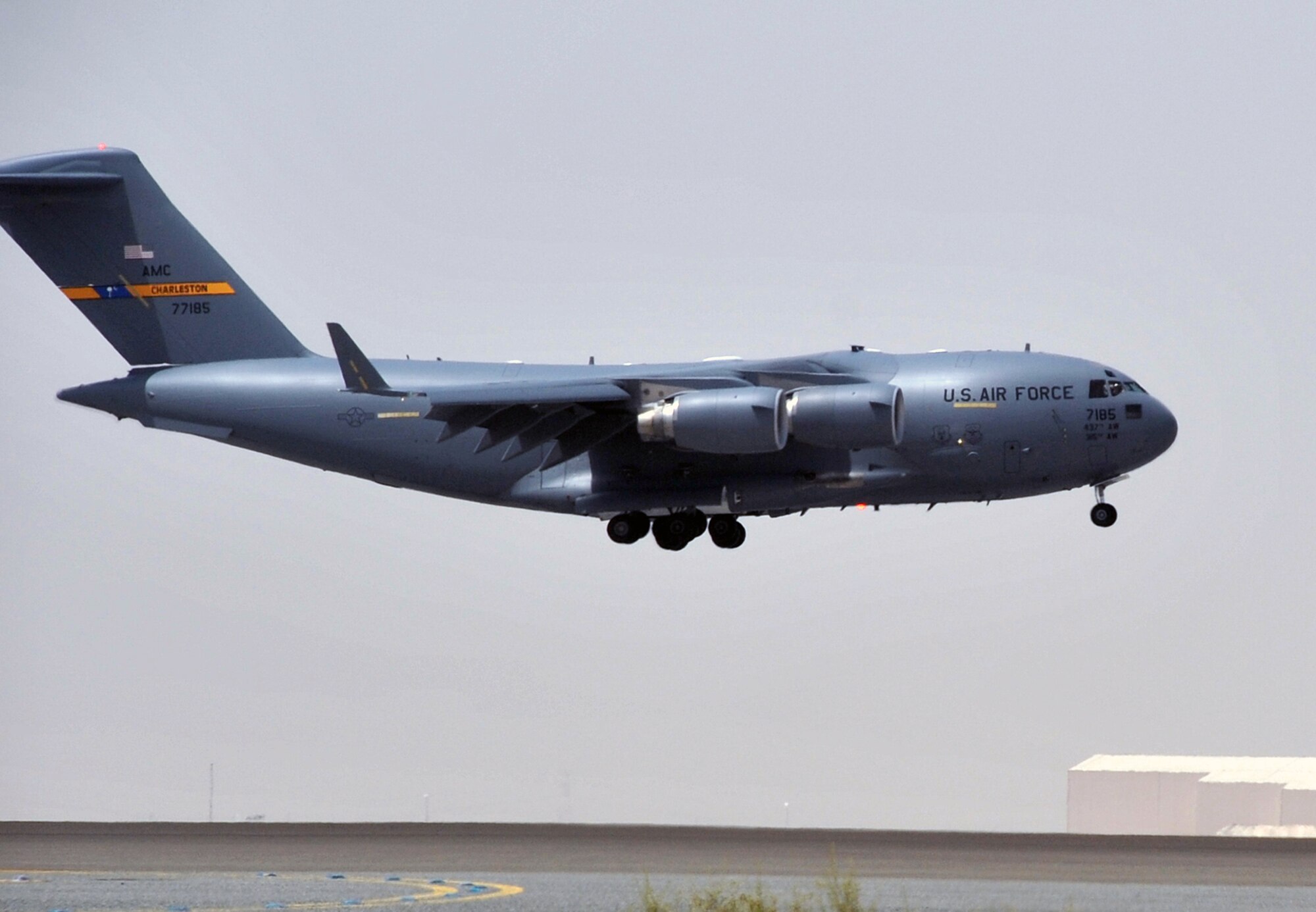 A C-17 Globemaster III deployed from Joint Base Charleston, S.C., comes in for a landing at a non-disclosed base in Southwest Asia after landing May 19, 2010. The C-17 stopped at the base to deliver cargo and passengers for the 380th Air Expeditionary Wing. According to its Air Force fact sheet, the C-17 Globemaster III is the newest, most flexible cargo aircraft to enter the airlift force. The C-17 is capable of rapid strategic delivery of troops and all types of cargo to main operating bases or directly to forward bases in the deployment area. (U.S. Air Force Photo/Master Sgt. Scott T. Sturkol/Released)