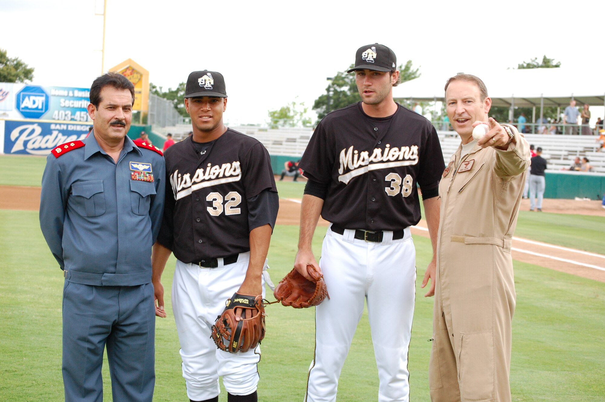 From left to right, Maj. Gen. Mohammad Dawran, Afghan National army air corps, Missions 2nd Baseman Jorge Minyeti, Missions Pitcher Craig Italino and Brig. Gen. Michael Boera, Coalition Air Power Transition Force commanding general, pose for a photo after throwing out the dual-first pitch of the game at Wolf Stadium May 23 in San Antonio, Texas. General Dawran is visiting Air Education and Training Command to receive updated information on current and future security assistance and cooperation training for the ANAAC. General Boera is working to stand up a robust ANAAC center of excellence and he is exploring more in-depth maintenance training between the two nations. Since the establishment of the Kabul Air Corps Training Center in 2007, in Afghanistan, more than 1,100 Afghani military members have received training in air corps orientation, air traffic control, fire fighting, aircraft maintenance, loadmaster duties and gunner training. (U.S. Air Force photo/Master Sgt. Paul Kilgallon)
