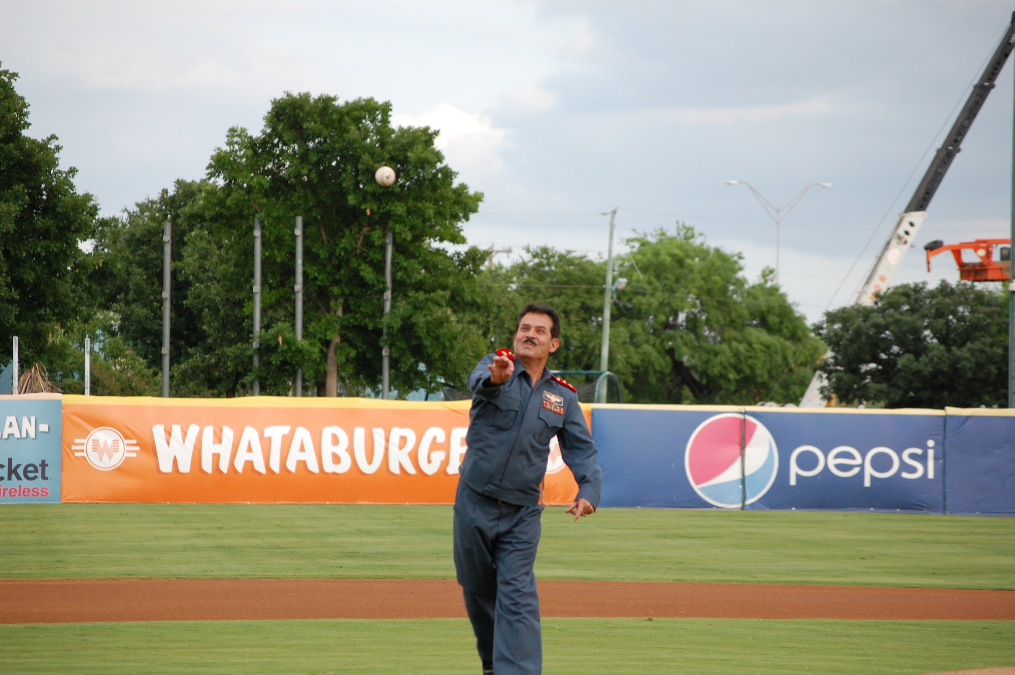 Maj. Gen. Mohammad Dawran, Afghan National army air corps and Brig. Gen. Michael Boera, Coalition Air Power Transition Force commanding general throws out a dual-first pitch of the game May 23, at Wolf Stadium in San Antonio, Texas. General Dawran is visiting Air Education and Training Command to receive updated information on current and future security assistance and cooperation training for the ANAAC. General Boera is working to stand up a robust ANAAC center of excellence and he is exploring more in-depth maintenance training between the two nations. Since the establishment of the Kabul Air Corps Training Center in 2007, in Afghanistan, more than 1,100 Afghani military members have received training in air corps orientation, air traffic control, fire fighting, aircraft maintenance, loadmaster duties and gunner training. (U.S. Air Force photo/Master Sgt. Paul Kilgallon) 