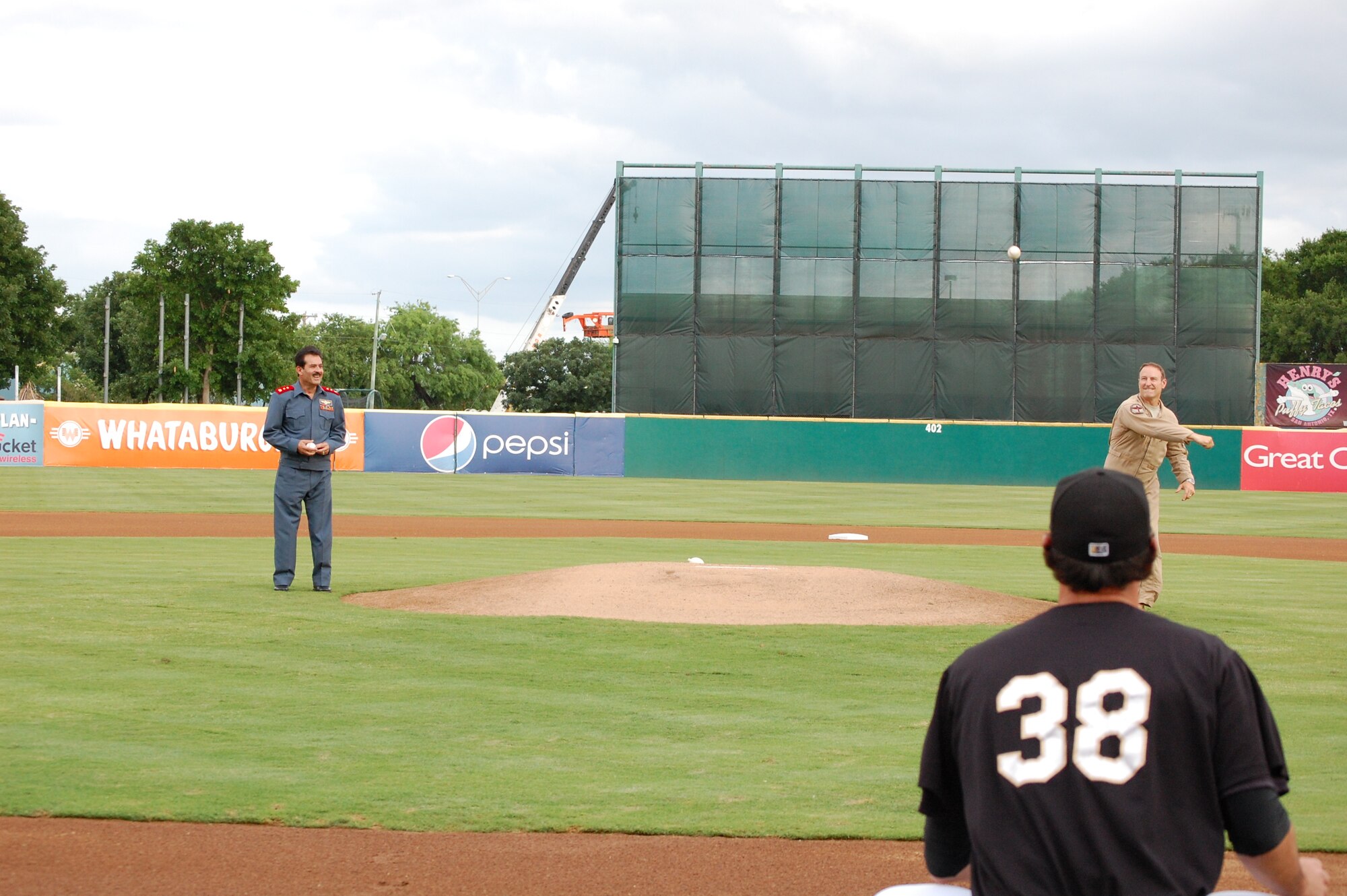 Brig. Gen. Michael Boera, Coalition Air Power Transition Force commanding general, right, and Maj. Gen. Mohammad Dawran, Afghan National army air corps, left, throw out the dual-first pitch of the game May 23, at Wolf Stadium in San Antonio, Texas. General Dawran is visiting Air Education and Training Command to receive updated information on current and future security assistance and cooperation training for the ANAAC. General Boera is working to stand up a robust ANAAC center of excellence and he is exploring more in-depth maintenance training between the two nations. Since the establishment of the Kabul Air Corps Training Center in 2007, in Afghanistan, more than 1,100 Afghani military members have received training in air corps orientation, air traffic control, fire fighting, aircraft maintenance, loadmaster duties and gunner training. (U.S. Air Force photo/Master Sgt. Paul Kilgallon) 