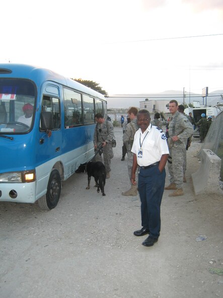 PORT-AU-PRINCE, Haiti -- Staff Sgt. Gary Magnelli, Airman 1st Class Donald Batan and Senior Airman Ryan Merrill, 823rd Expeditionary Security Forces Squadron members, help train members of the Haiti airport security team in how to search vehicles at the Toussaint L'Ouverture International Airport here in early February. The 823rd ESFS is close to completing their tour that began in January after an earthquake hit. (Contributed photo/RELEASED) 